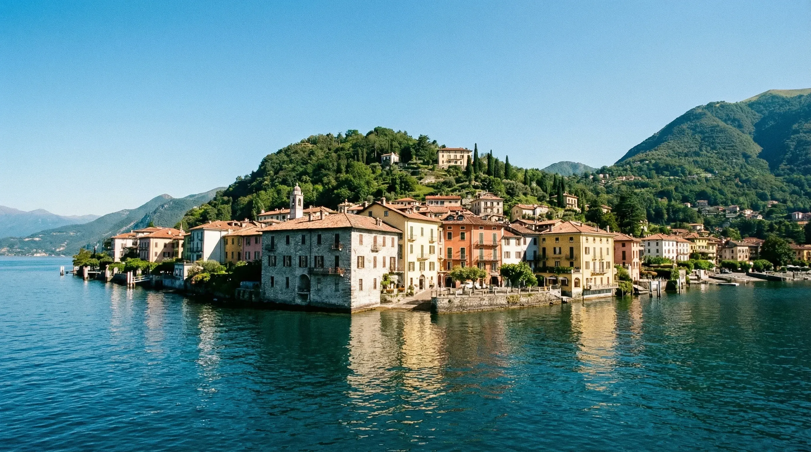 The colorful lakeside town of Bellagio nestled against green hills on the shore of Lake Como.