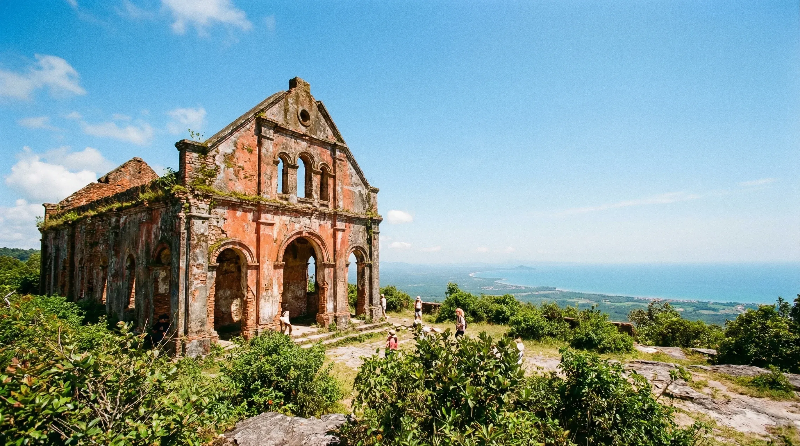 An old red stone church on a mountain plateau overlooking the Cambodian coast and Gulf of Thailand.