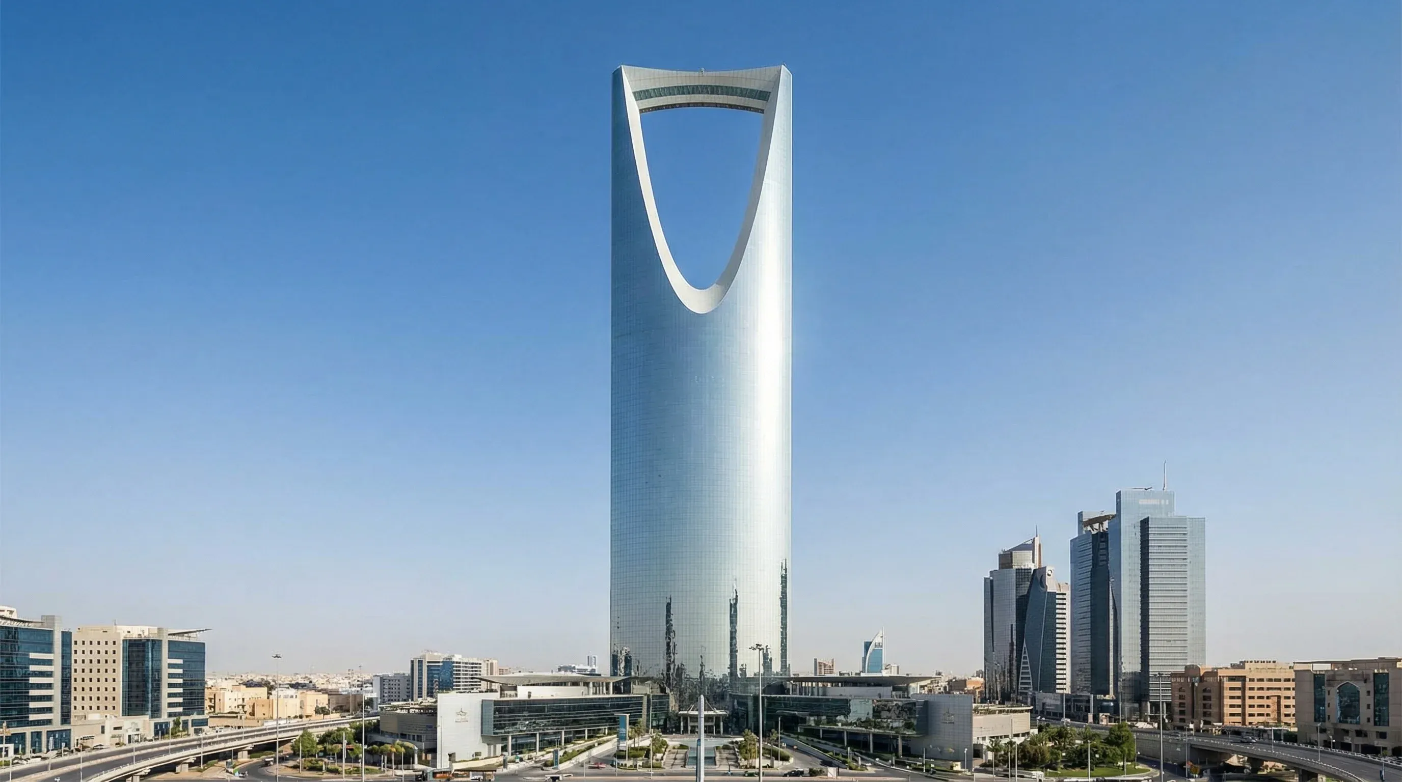 The Kingdom Centre skyscraper with its iconic skybridge under a clear blue sky in Riyadh.