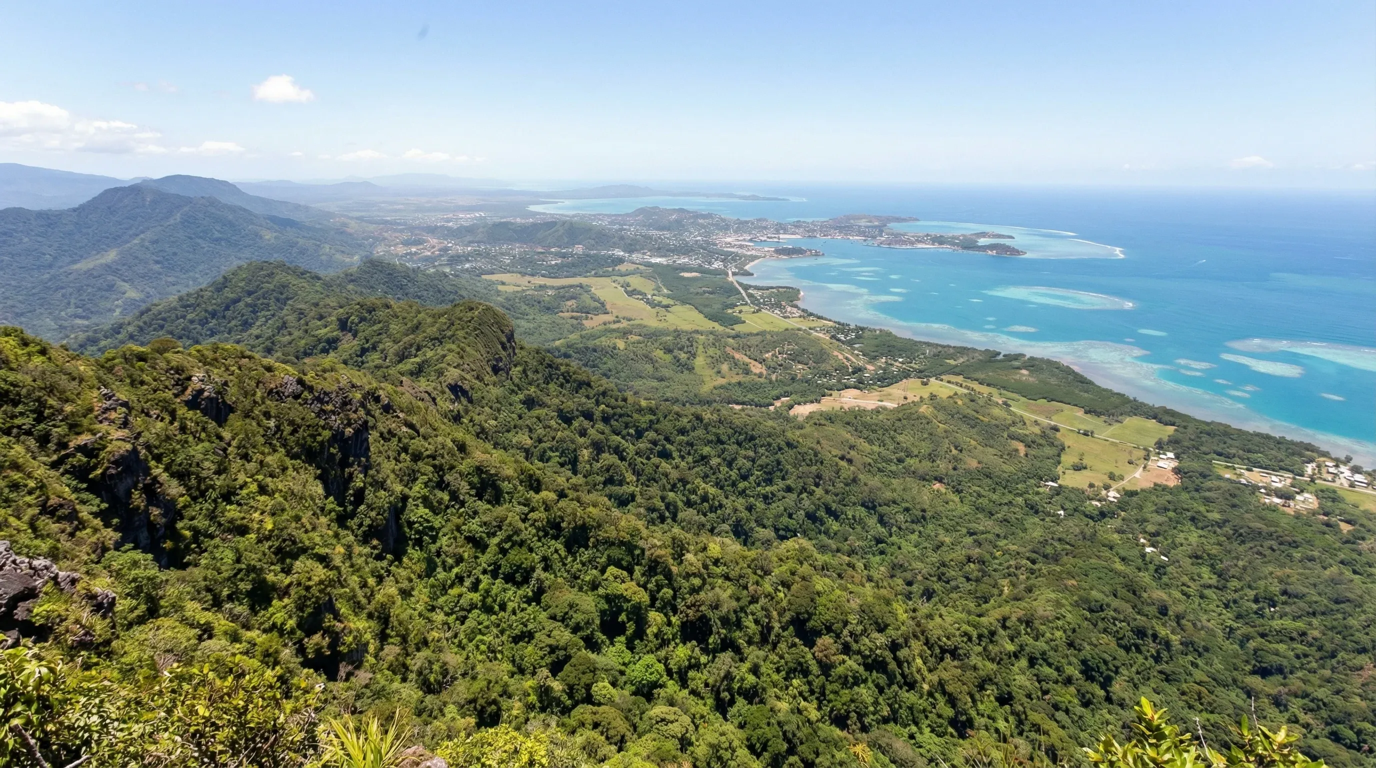 A panoramic view from Varirata National Park showing forested mountain ridges leading down to the coastline of Port Moresby.
