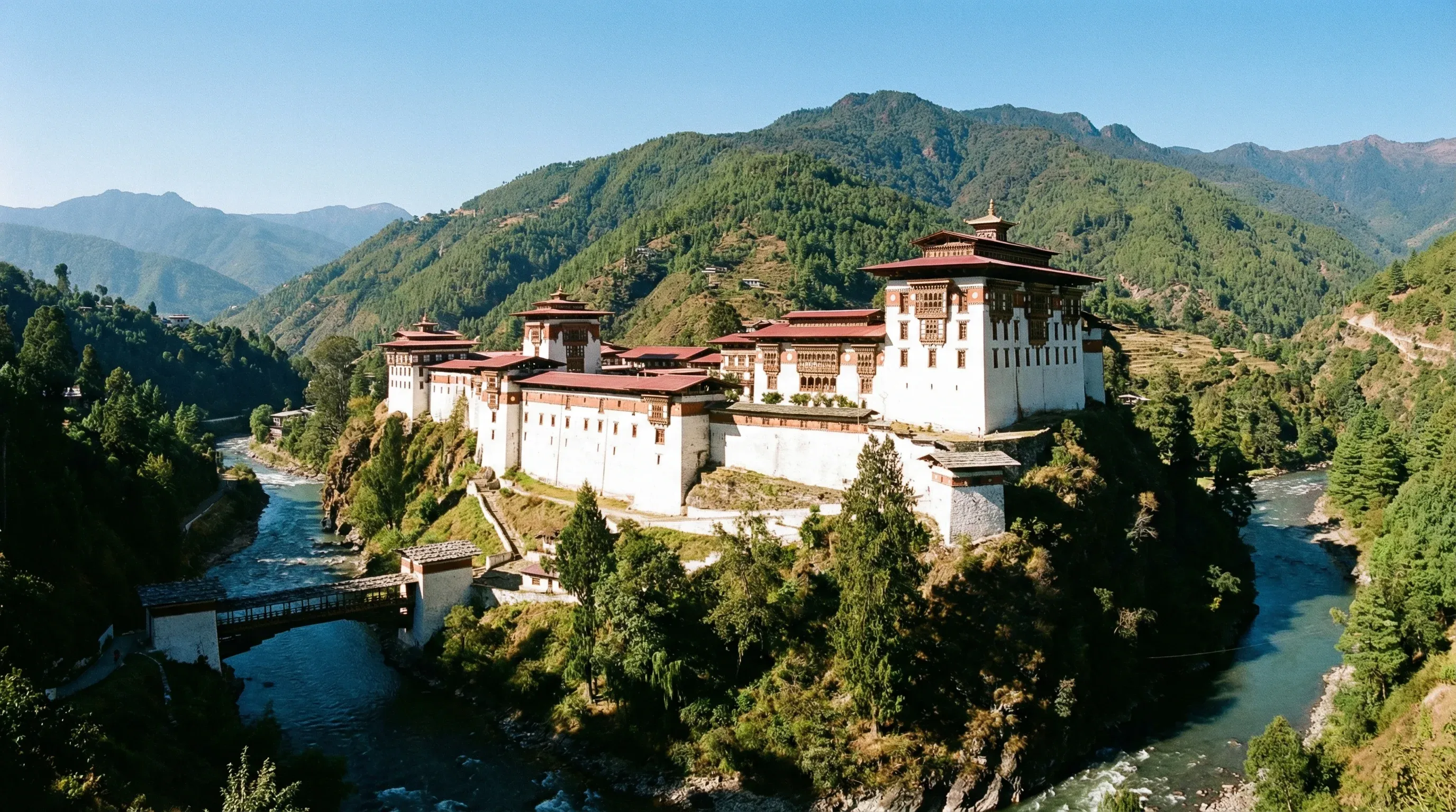 A wide-angle view of the large white Trongsa Dzong fortress built on a mountain ridge in Central Bhutan.