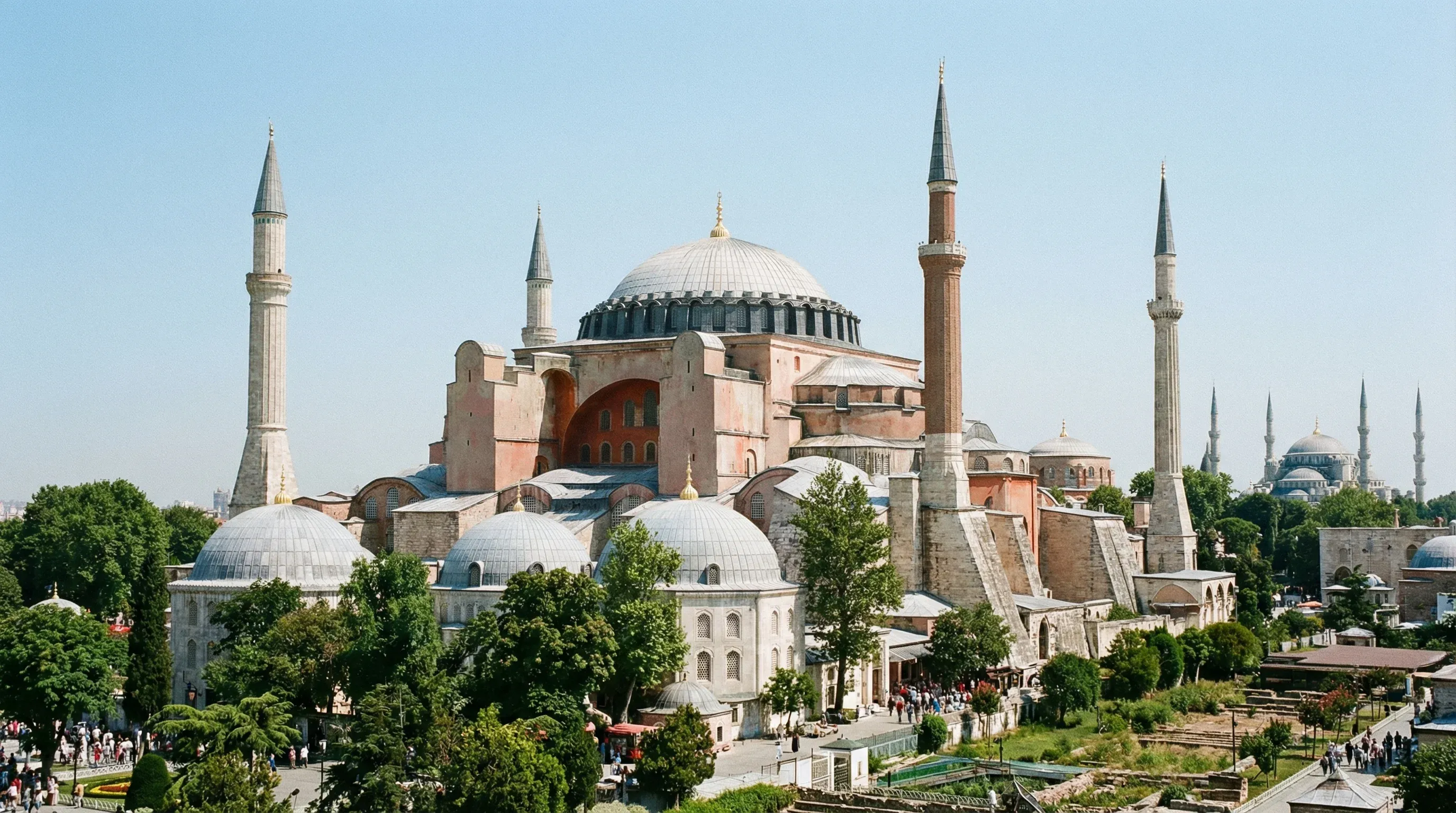 The exterior of the Hagia Sophia showing its large central dome and four minarets in Istanbul.