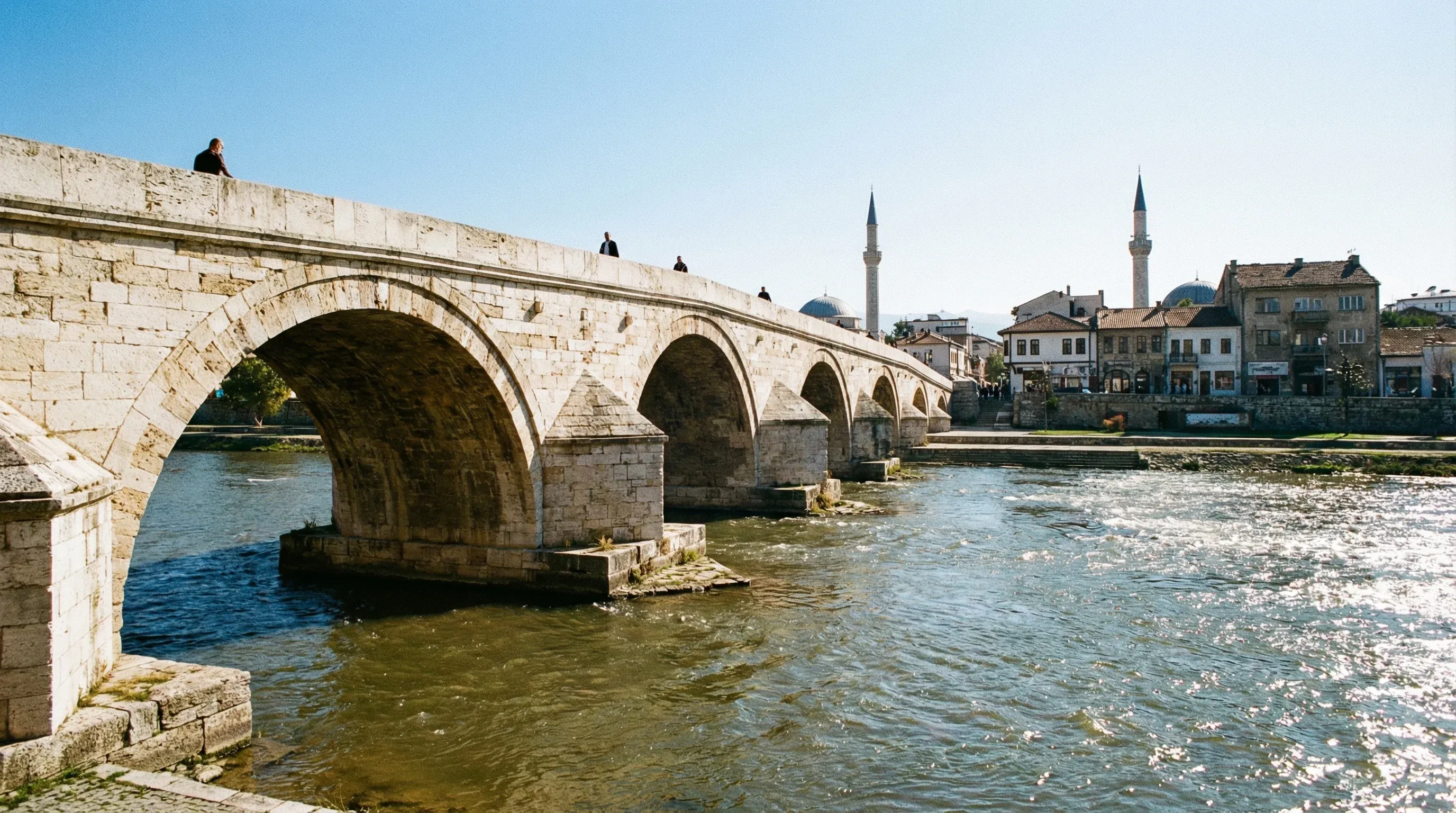 The historic multi-arched Ottoman Stone Bridge over the Vardar River in the center of Skopje.