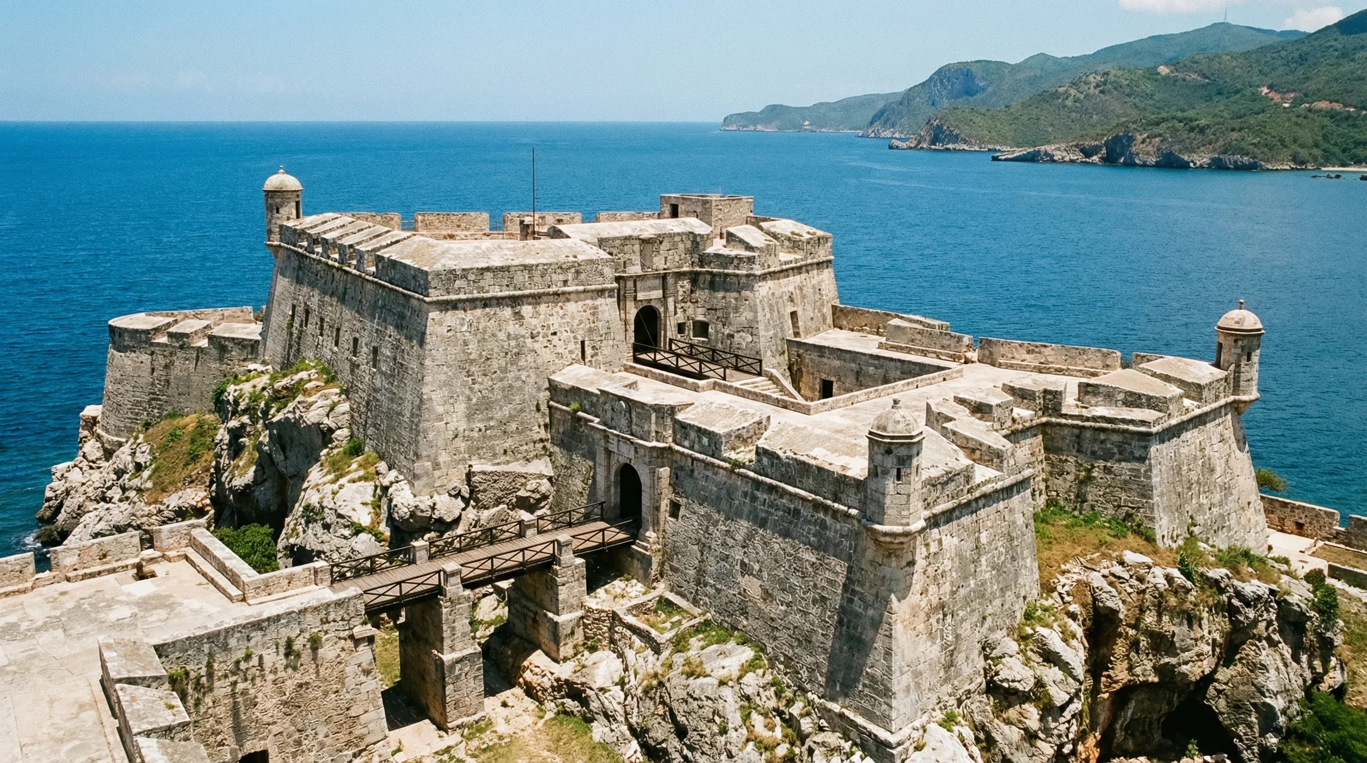 The historic stone fortifications of Castillo de San Pedro de la Roca on a cliff overlooking the sea in Santiago de Cuba.