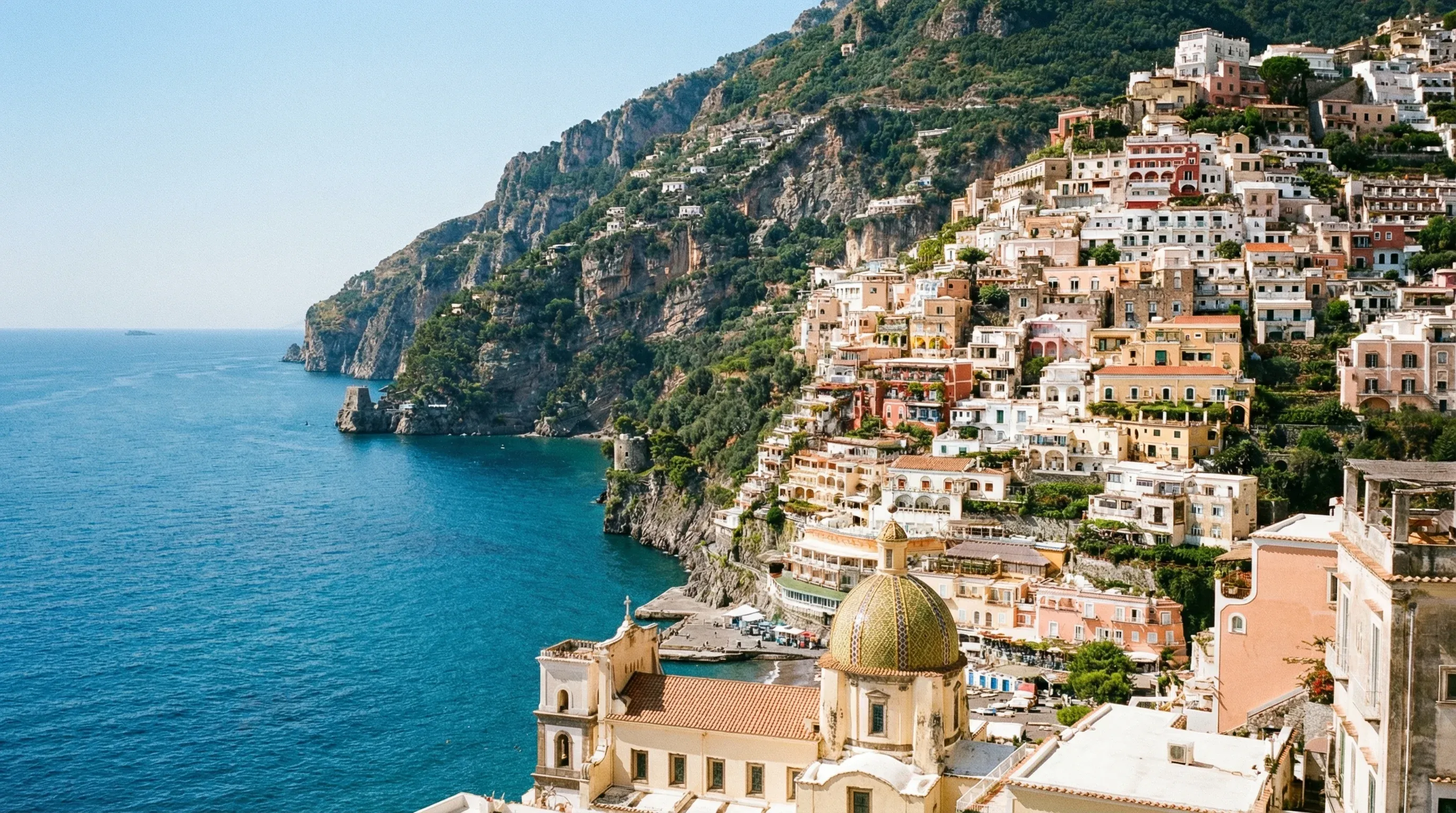 Colorful houses built into the steep cliffs of Positano overlooking the Tyrrhenian Sea on the Amalfi Coast.
