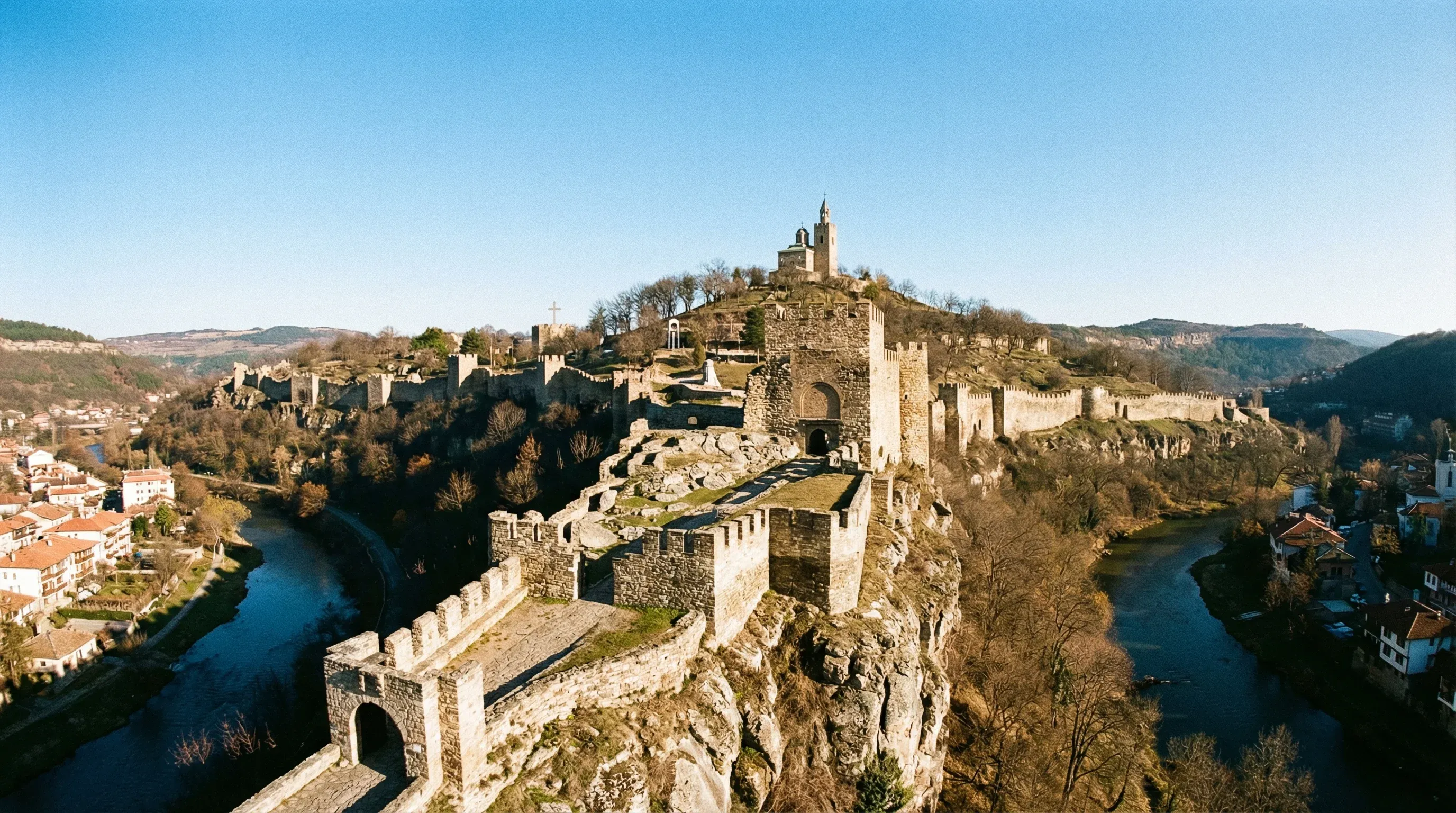 The medieval Tsarevets Fortress in Veliko Tarnovo, Bulgaria, showing stone walls and the Patriarchal Cathedral on a clear day.