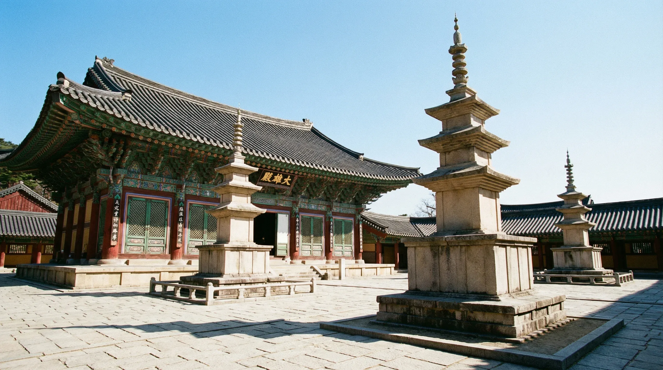 Two ancient stone pagodas and traditional wooden buildings at Bulguksa Temple in Gyeongju.