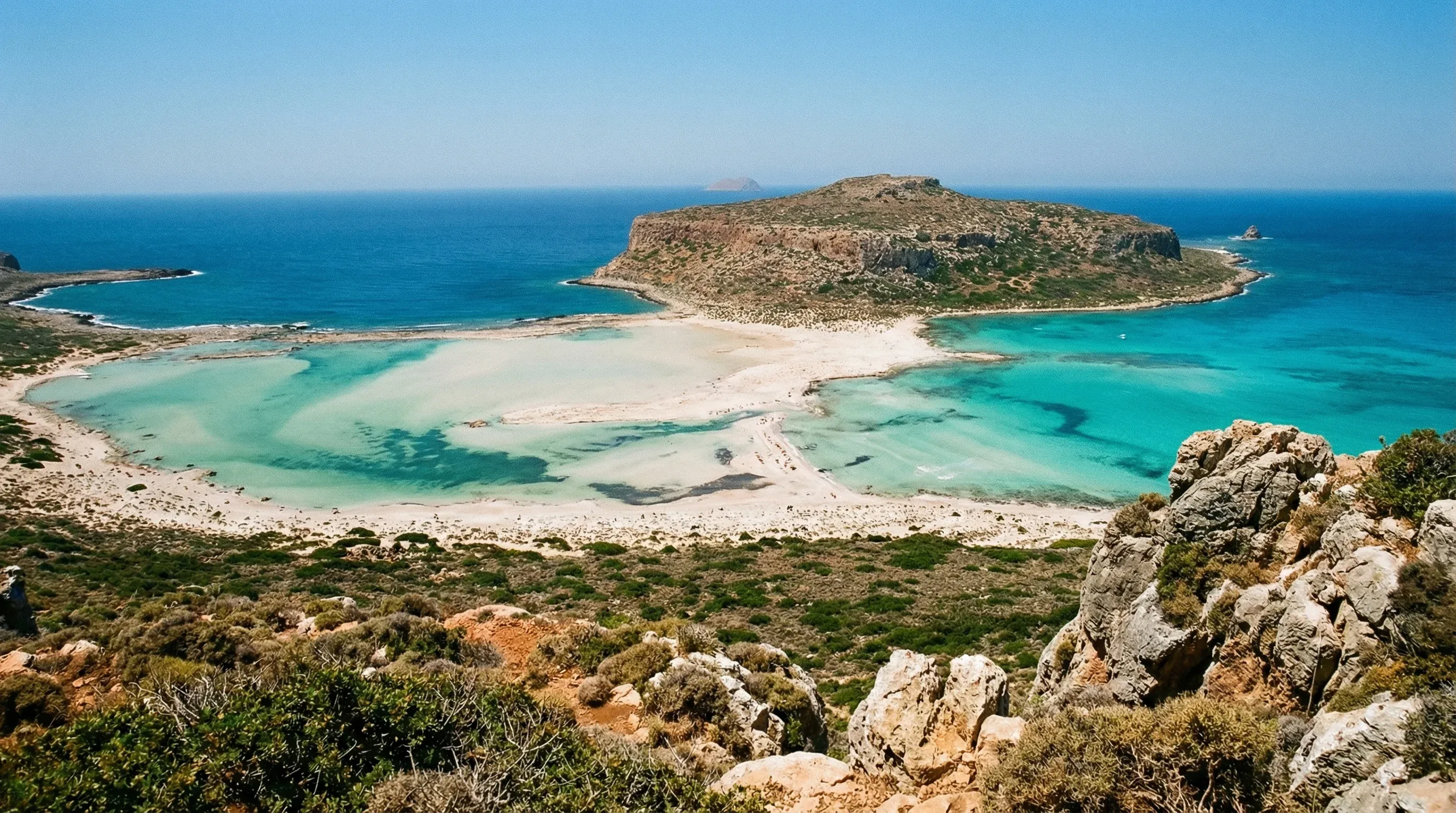 High-angle view of the turquoise waters and white sand of Balos Lagoon in Crete.