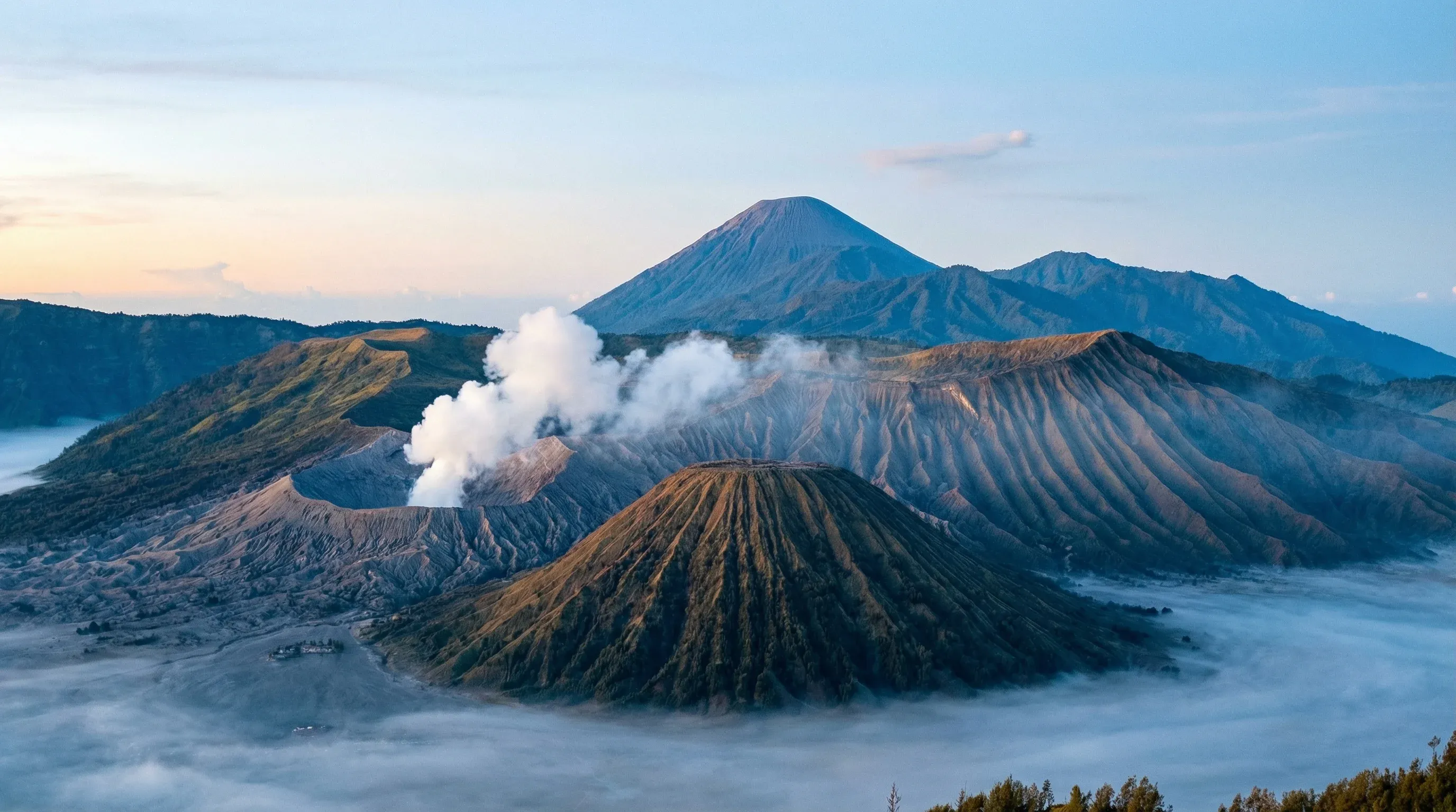 The volcanic peaks of Mount Bromo and Mount Batok within the Tengger caldera at sunrise in East Java.