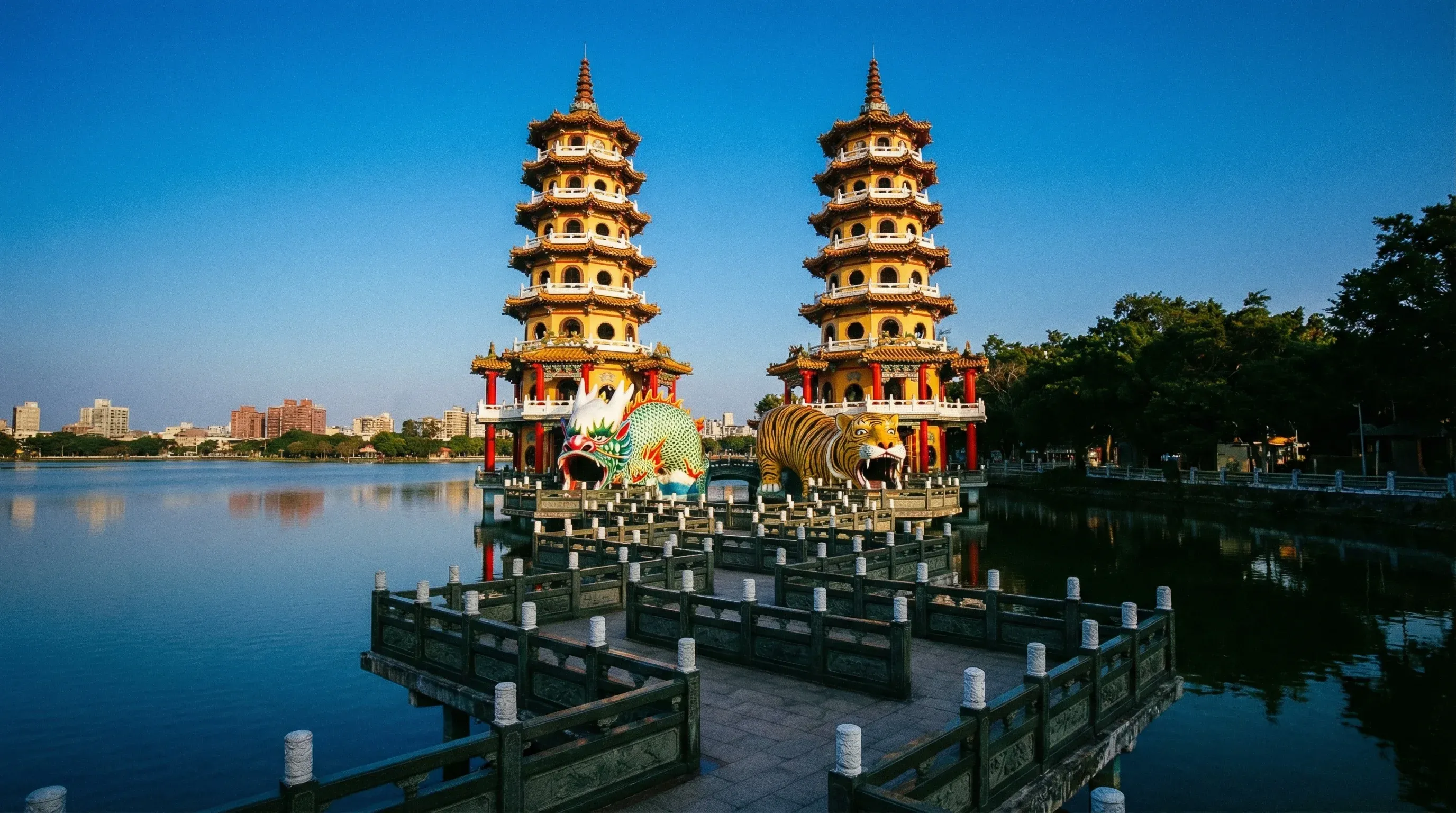 Two colourful seven-story pagodas at the end of a bridge on Lotus Pond in Kaohsiung.