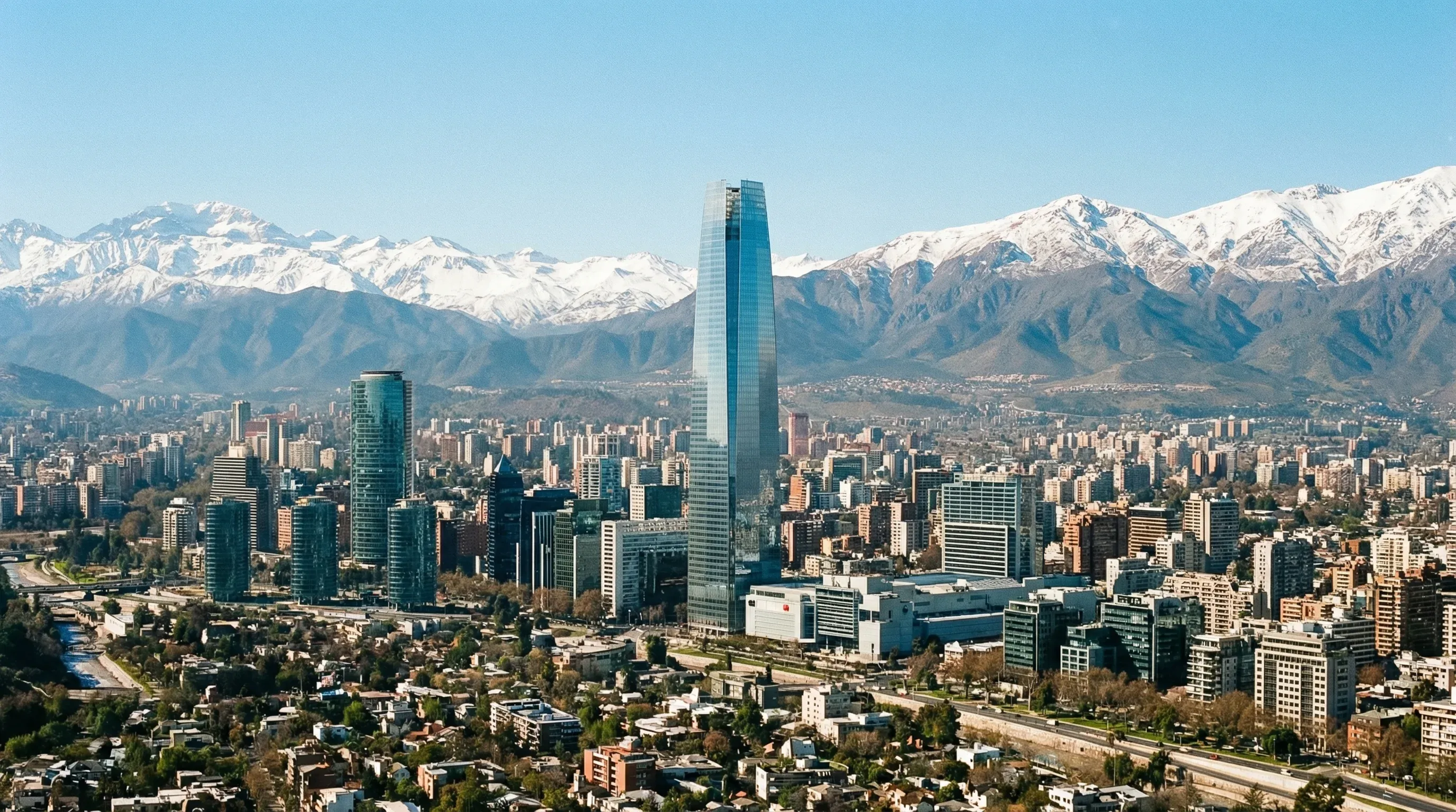 Cityscape of Santiago featuring modern skyscrapers with the snow-capped Andes Mountains in the background.