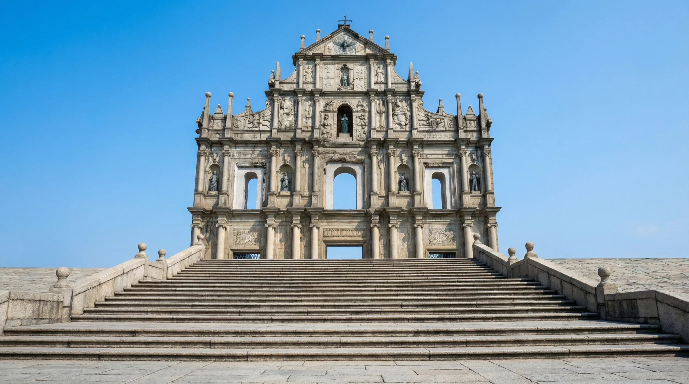 The stone facade of the 17th-century Ruins of Saint Paul's standing at the top of a stone staircase.