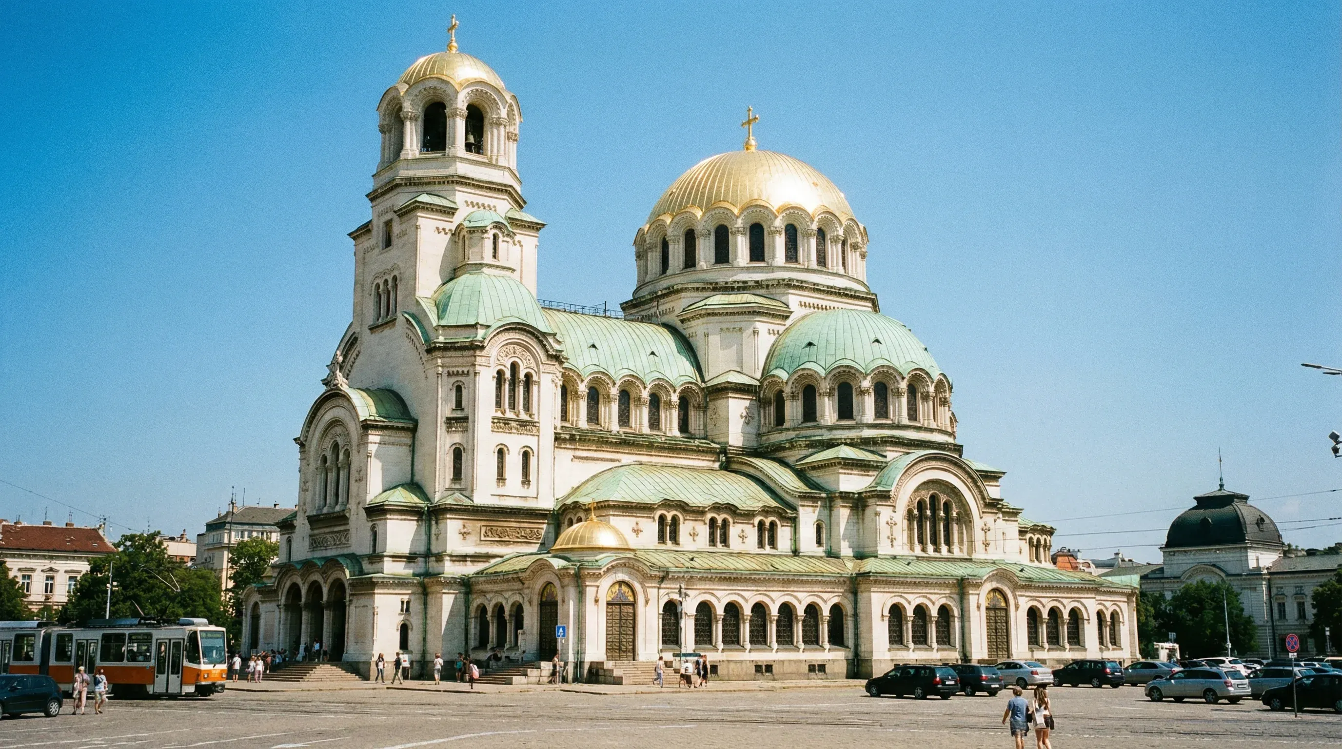 The gold-domed Alexander Nevsky Cathedral in Sofia, Bulgaria, viewed from the square on a clear, sunny day.