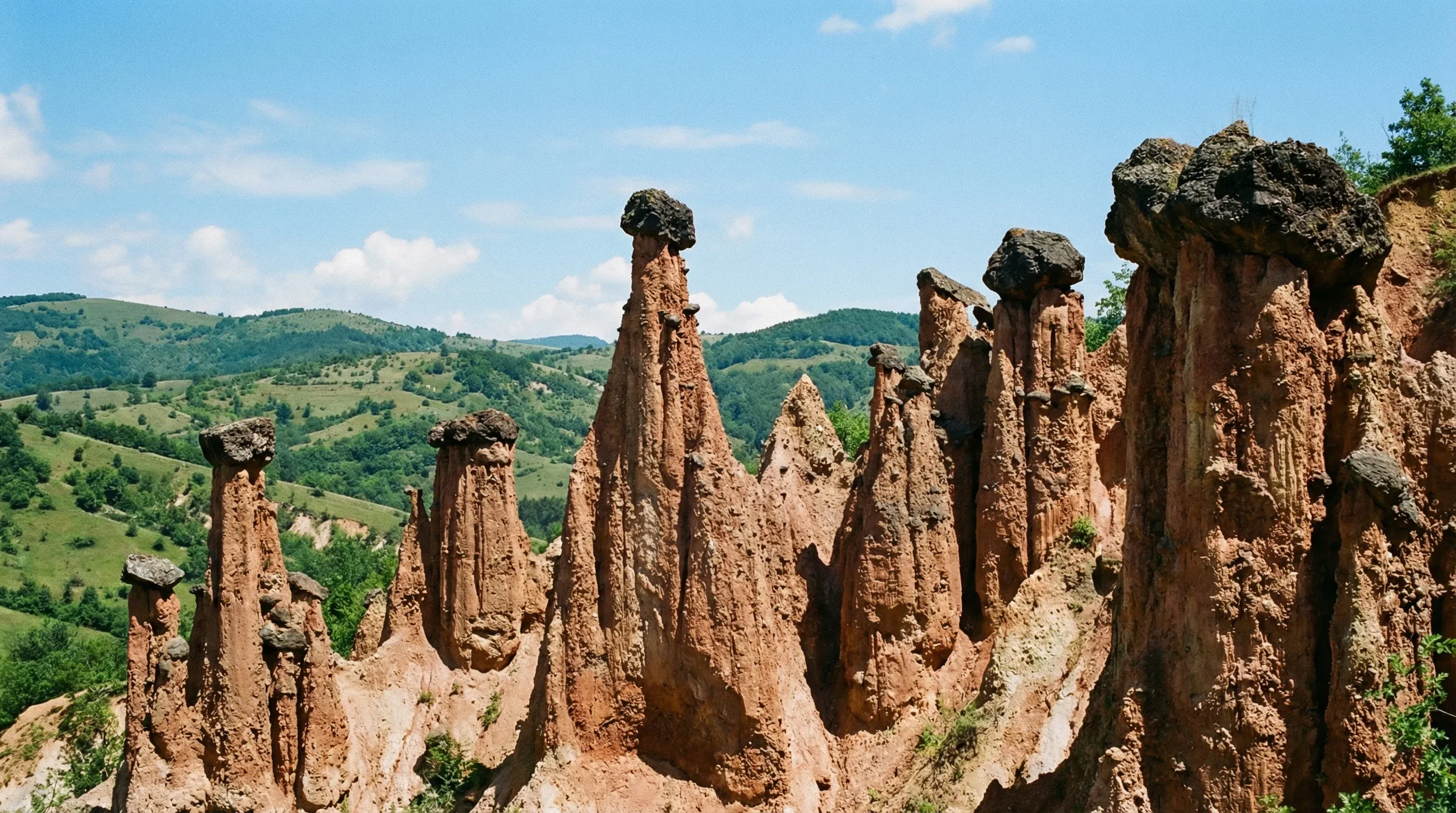 A cluster of naturally formed earth pyramids with stone caps at the Đavolja Varoš site in Southern Serbia.