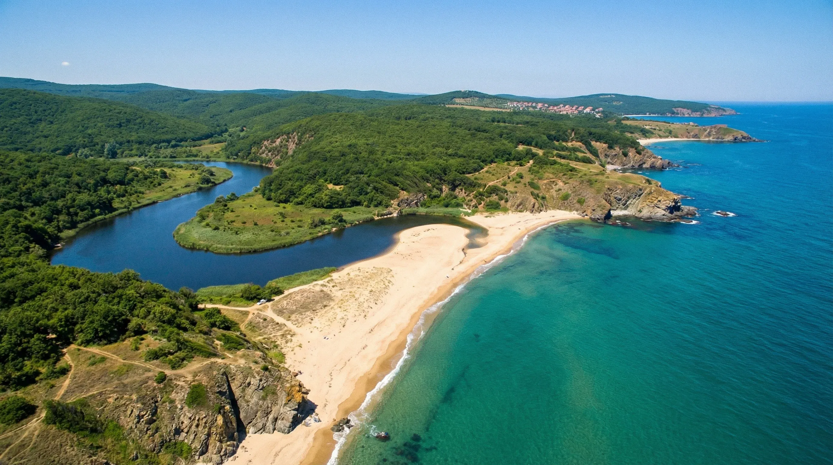 An aerial view of the Veleka River meeting the Black Sea at a sandy beach spit in Sinemorets, Southeast Bulgaria.