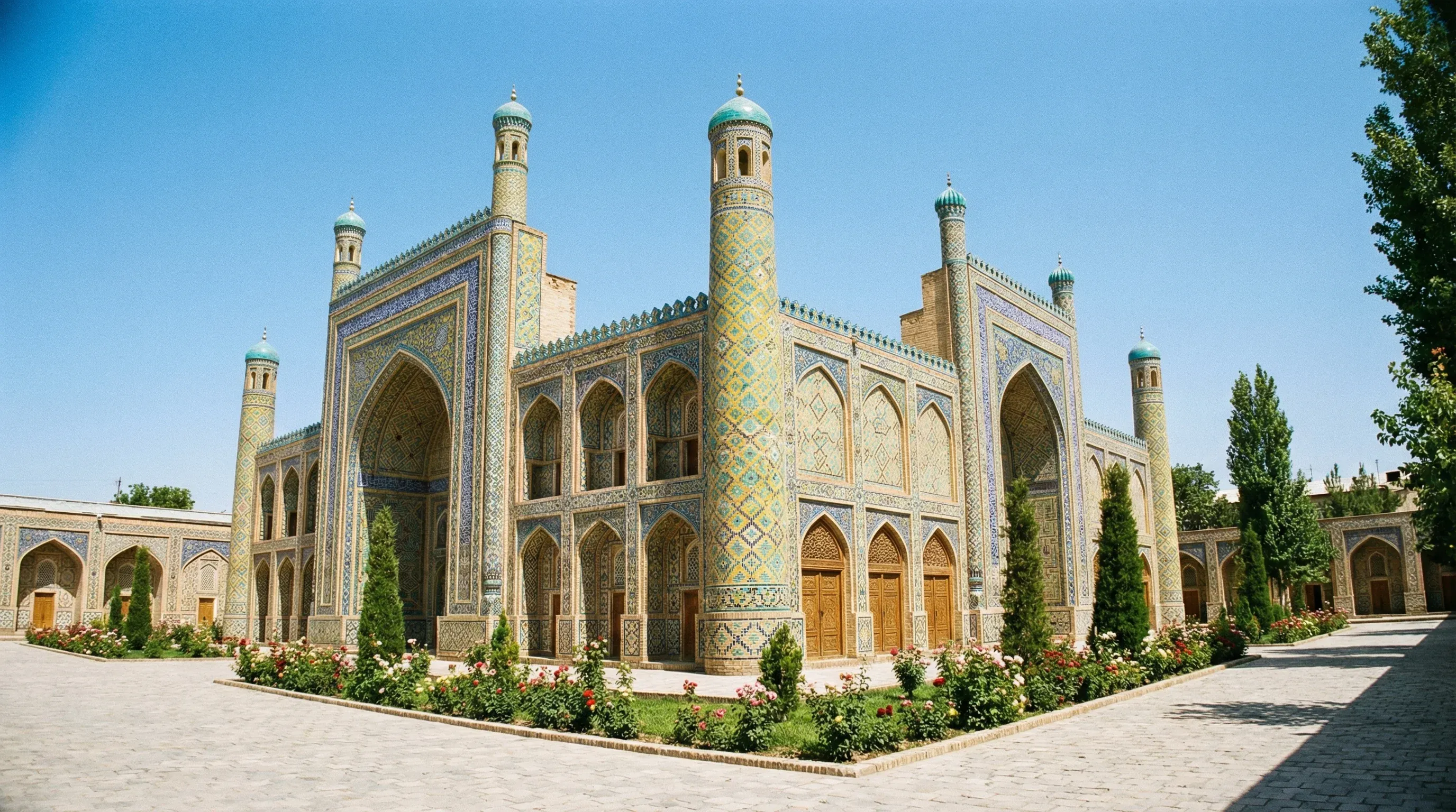 The colorful tiled facade and minarets of the Palace of Khudayar Khan in Kokand, Fergana Valley.