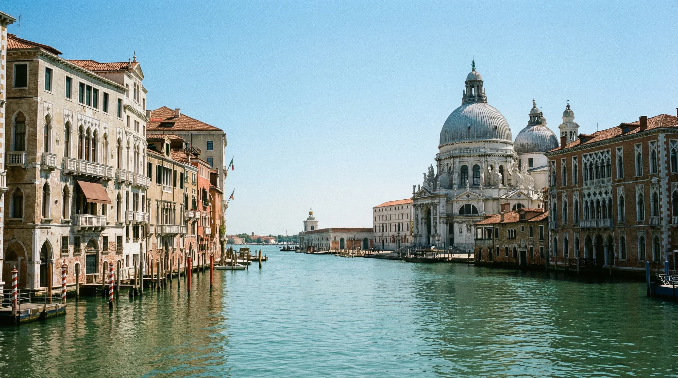 The Grand Canal in Venice with the large domed Basilica of Santa Maria della Salute in the background.