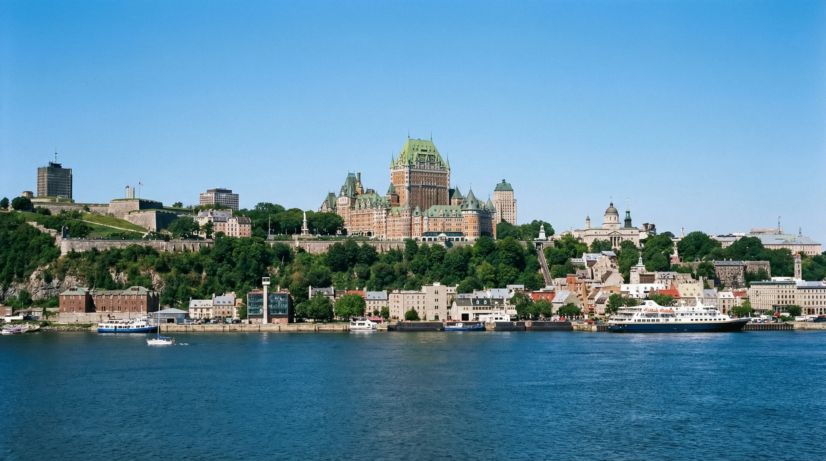 The historic Château Frontenac hotel and the fortified walls of Old Québec City seen from the St. Lawrence River.