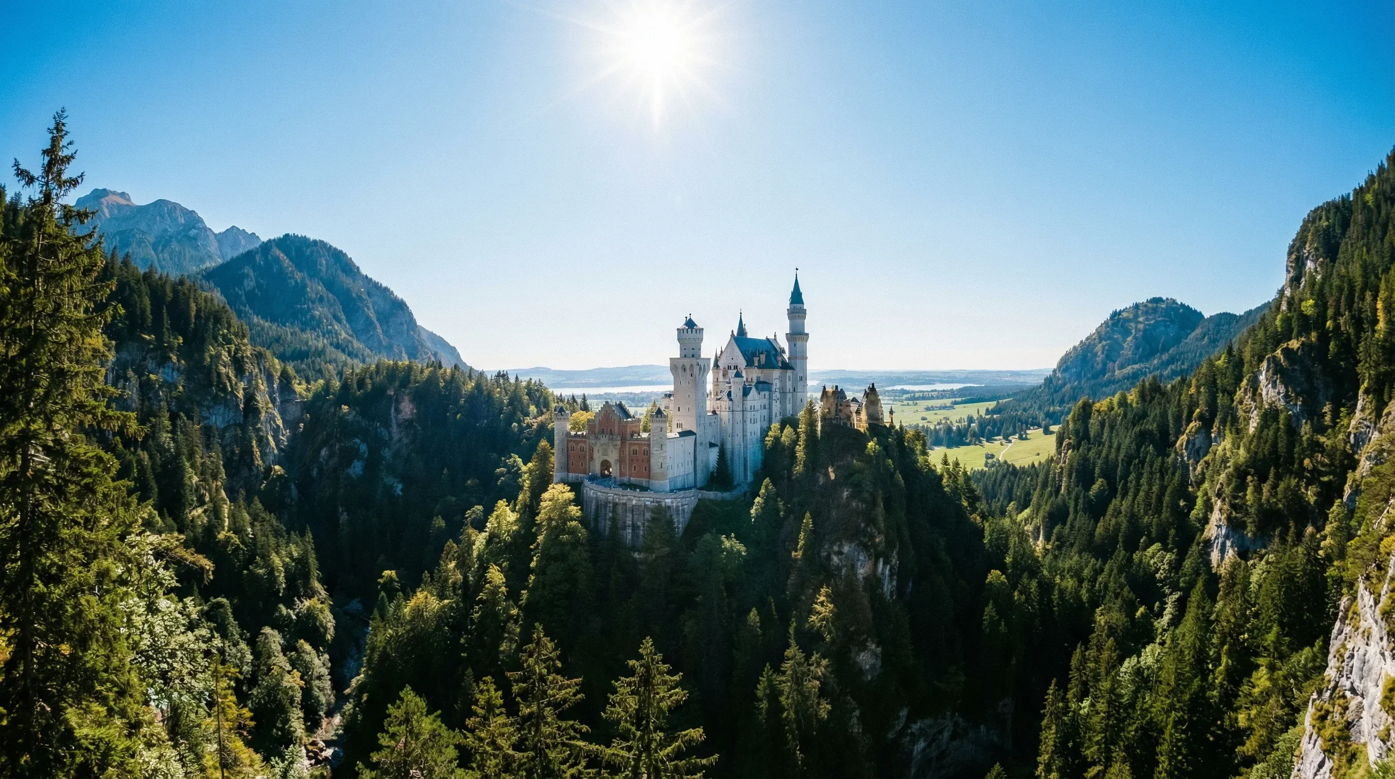 The white towers of Neuschwanstein Castle perched on a mountain ridge in the Bavarian Alps.