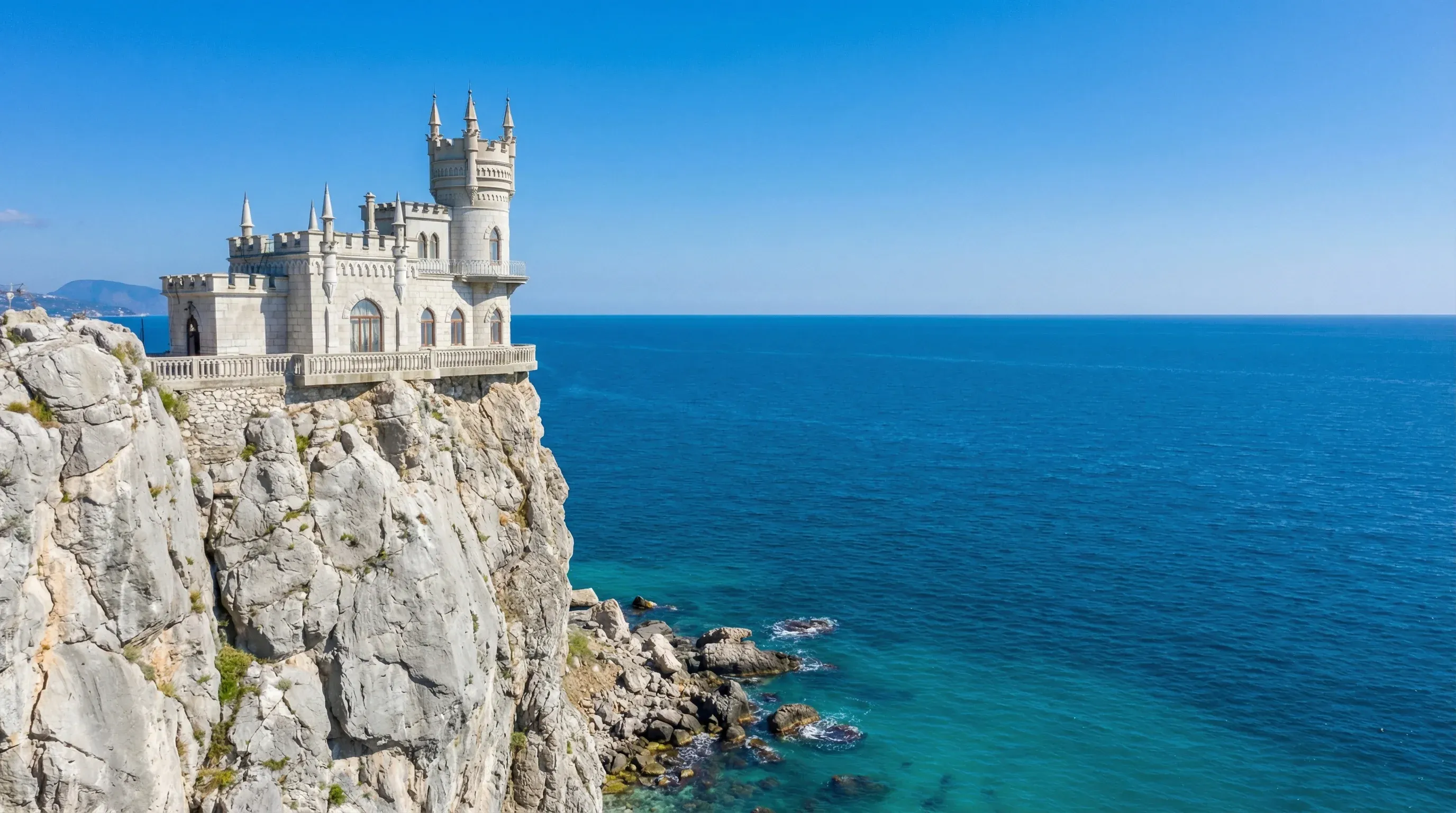 A small Neo-Gothic castle situated on a steep cliff overlooking the Black Sea coast in Crimea.