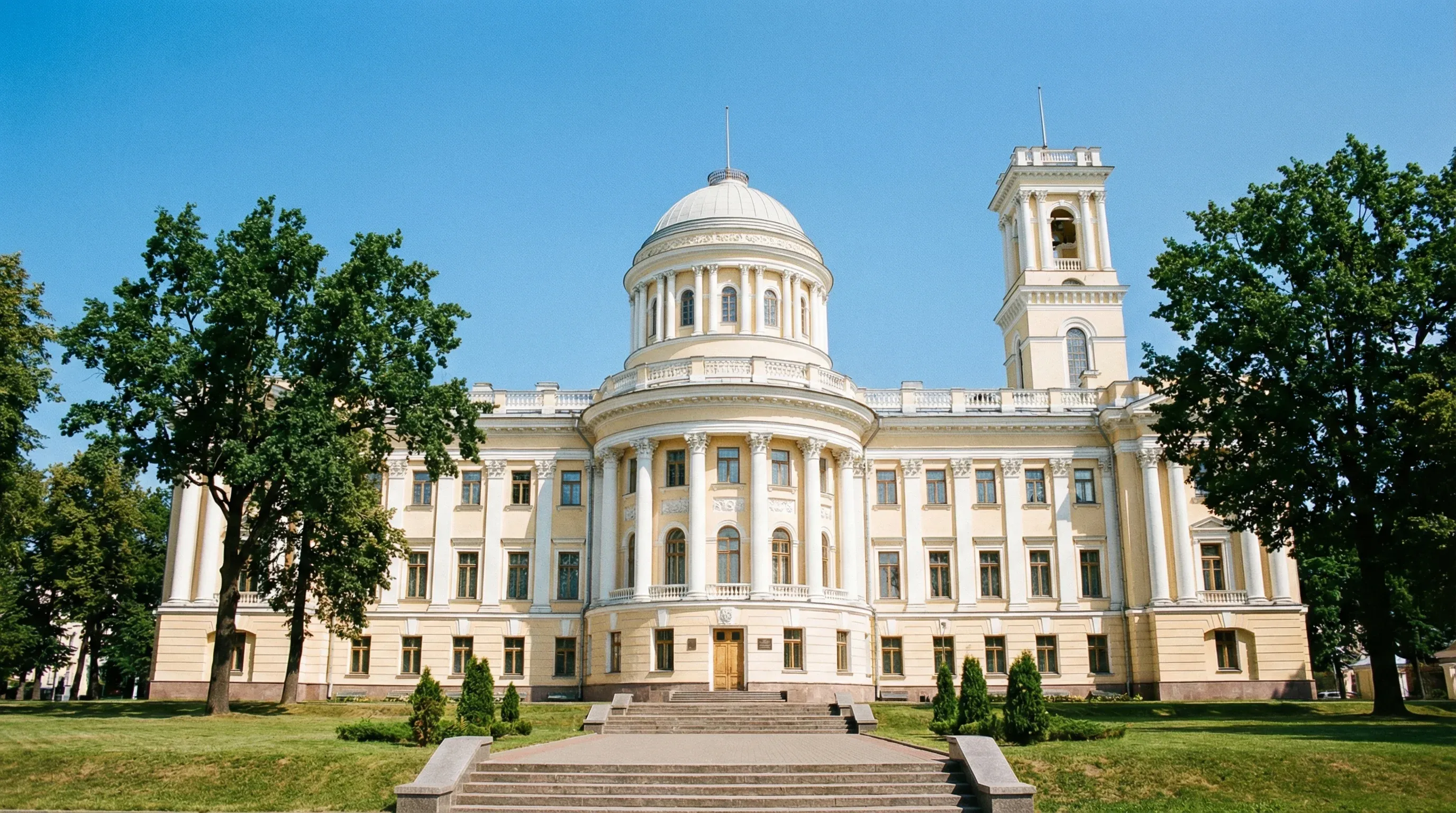 The neoclassical facade of the Rumyantsev-Paskevich Palace with white columns and a dome in Gomel.