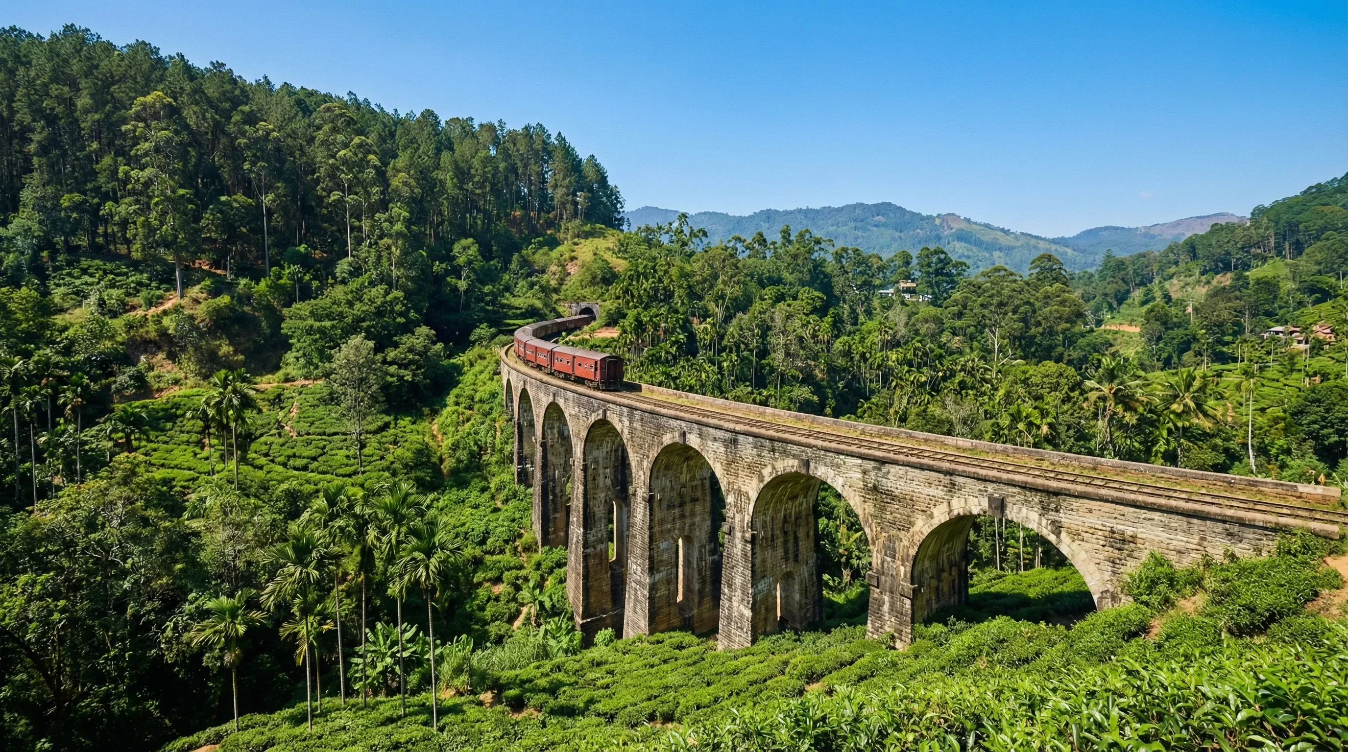 The stone Nine Arch Bridge spans a lush green valley in Ella, Sri Lanka.
