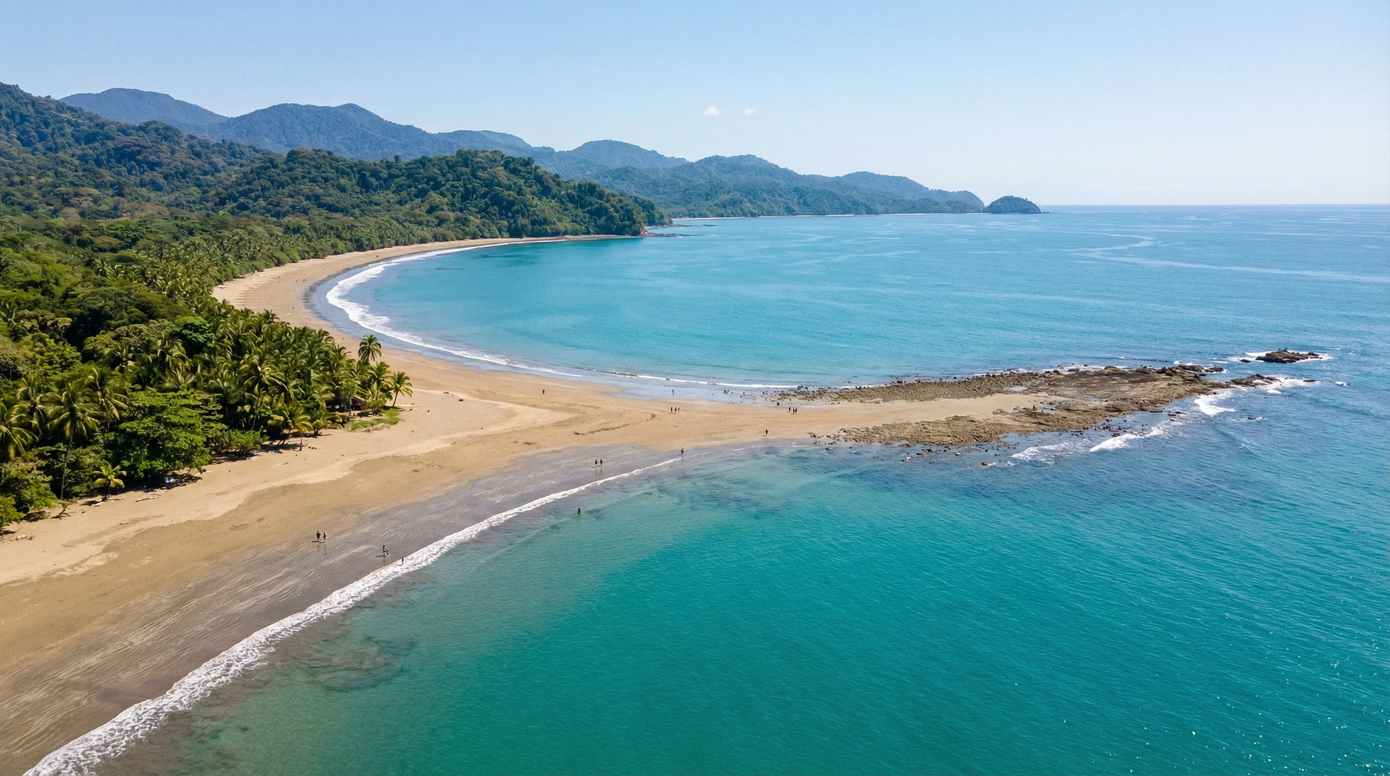 A high-angle view of the natural whale-tail-shaped sandbar formation at Marino Ballena National Park during low tide.
