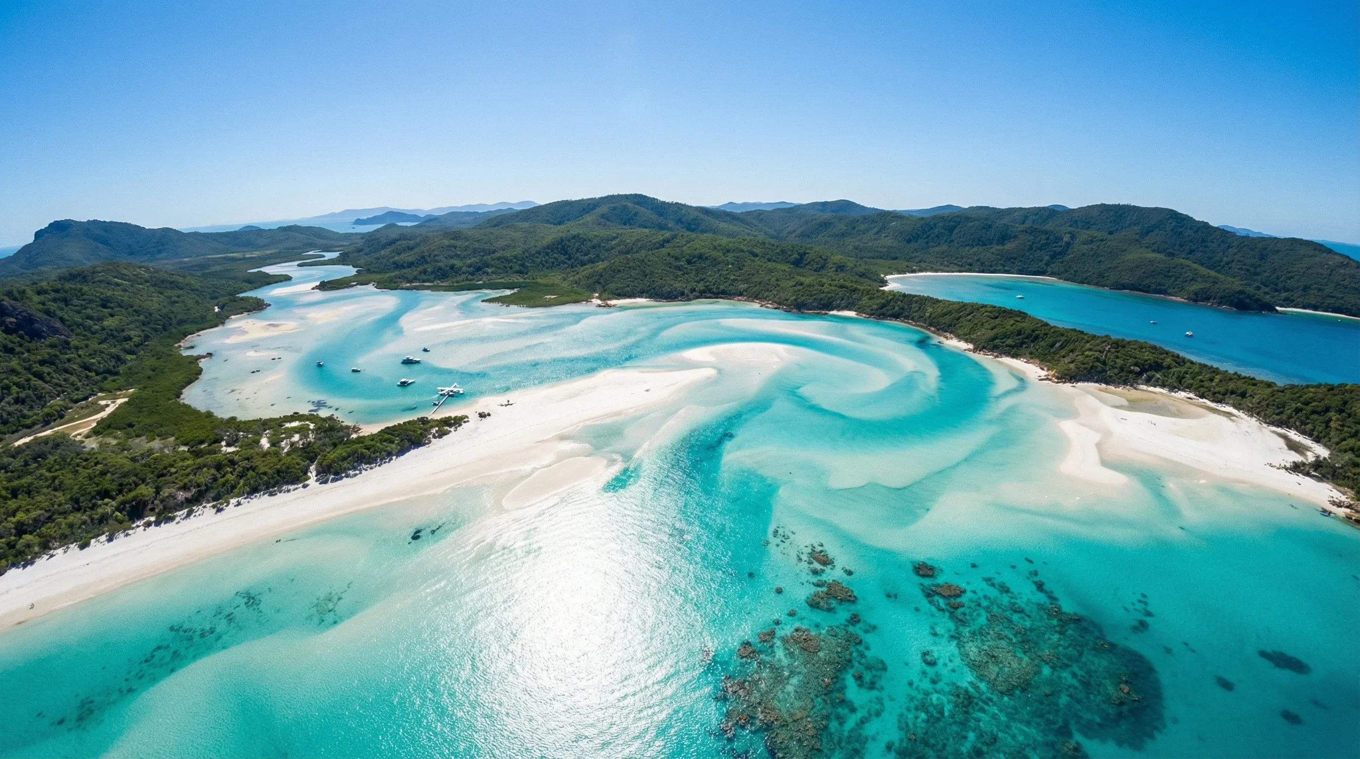 Aerial view of the swirling white sands and turquoise waters of Hill Inlet at Whitehaven Beach.