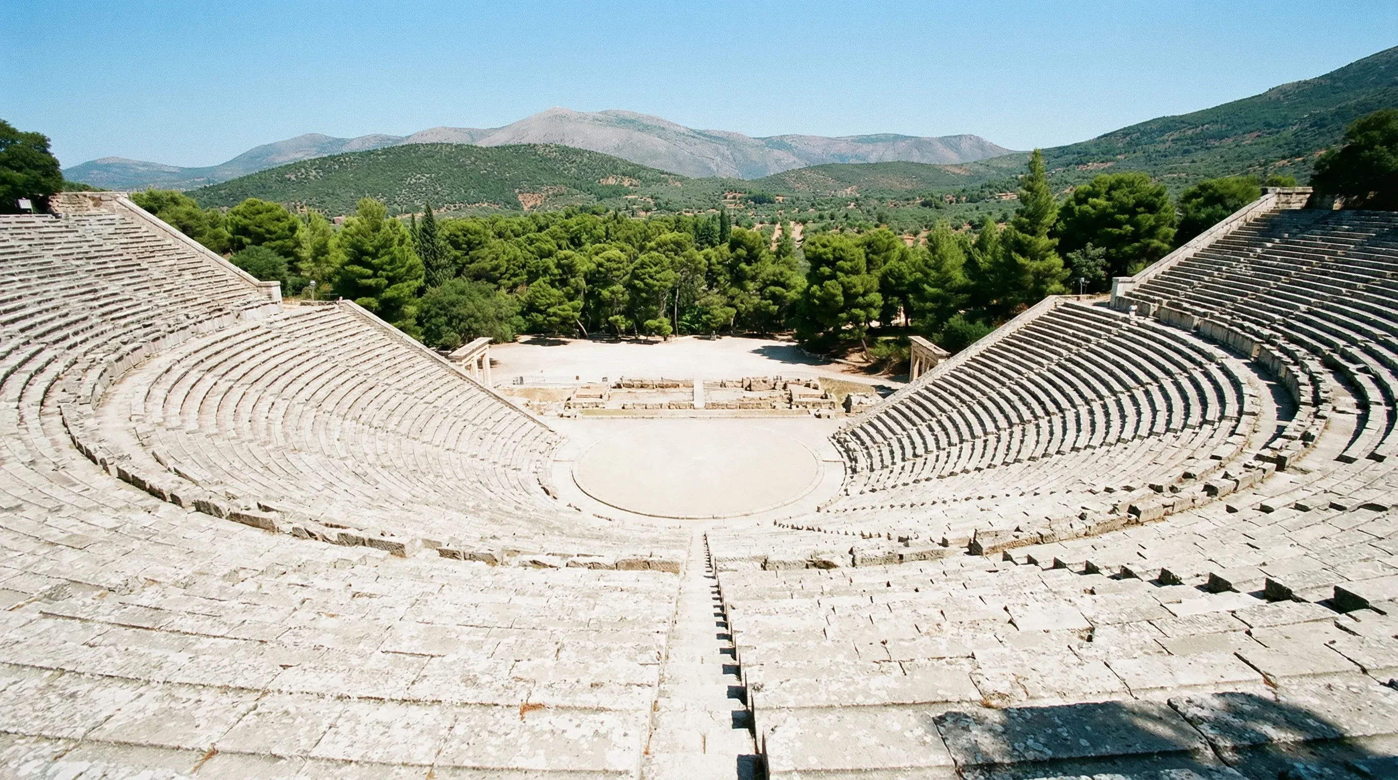 The well-preserved semicircular stone seating of the ancient Greek theatre at Epidaurus.