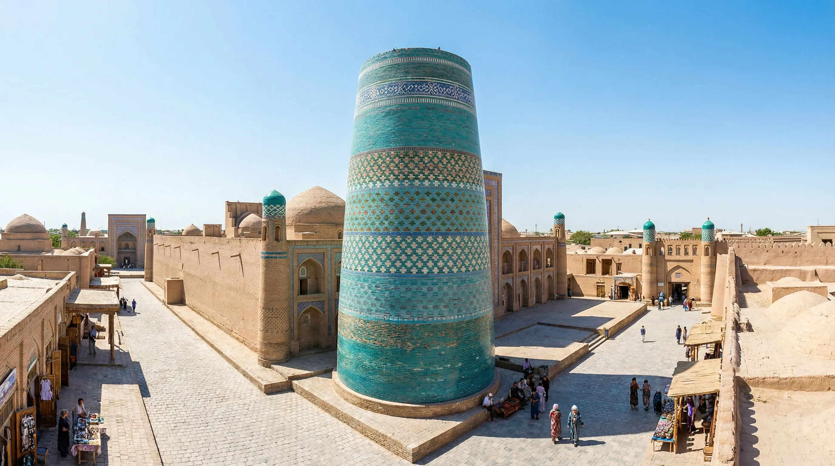 The turquoise-tiled Kalta Minor Minaret and the mud-brick architecture of the Itchan Kala fortress in Khiva.