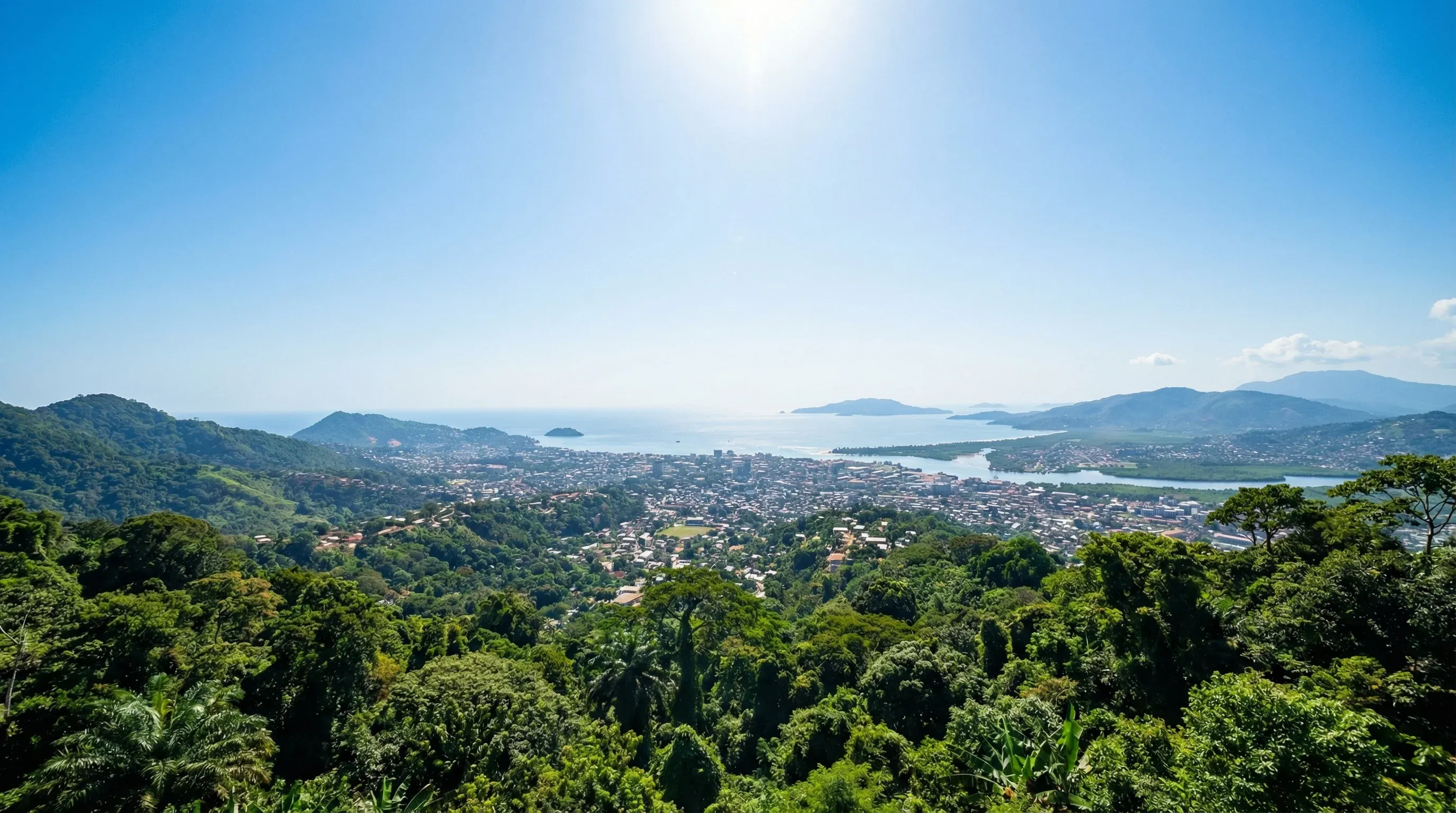An elevated panoramic view from Leicester Peak showing the city of Freetown, the coastline, and the Atlantic Ocean in Sierra Leone.