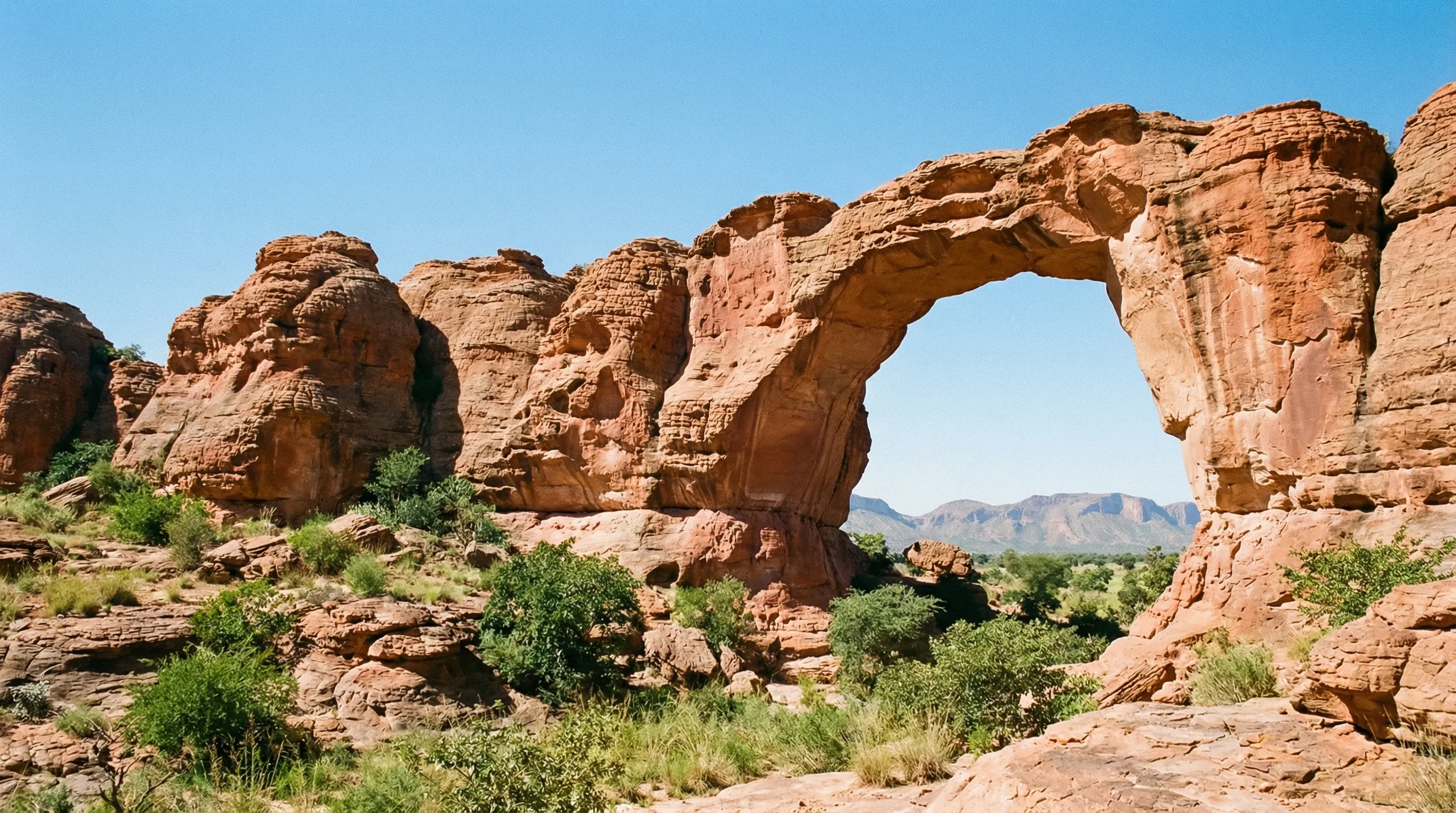 A large natural sandstone archway called Kamadjan Arch in the Manding Mountains near Siby, Mali.