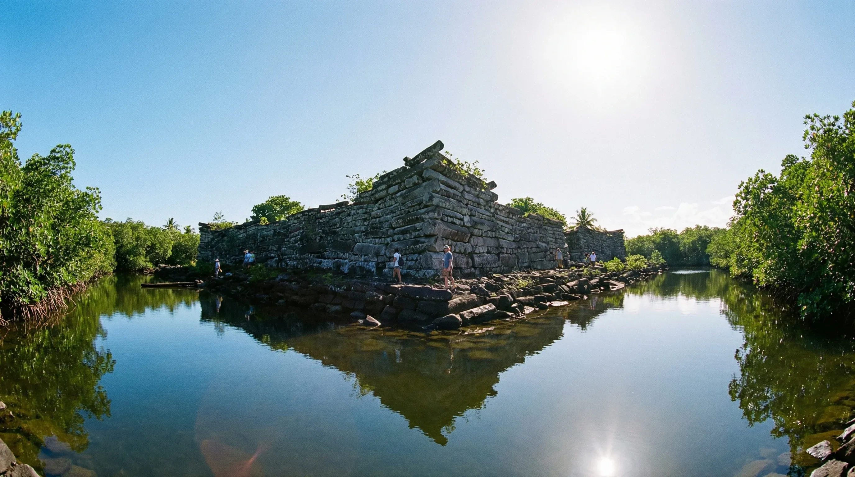 The massive stone walls of the ancient Nan Madol archaeological site rising from the water and mangroves on Pohnpei.