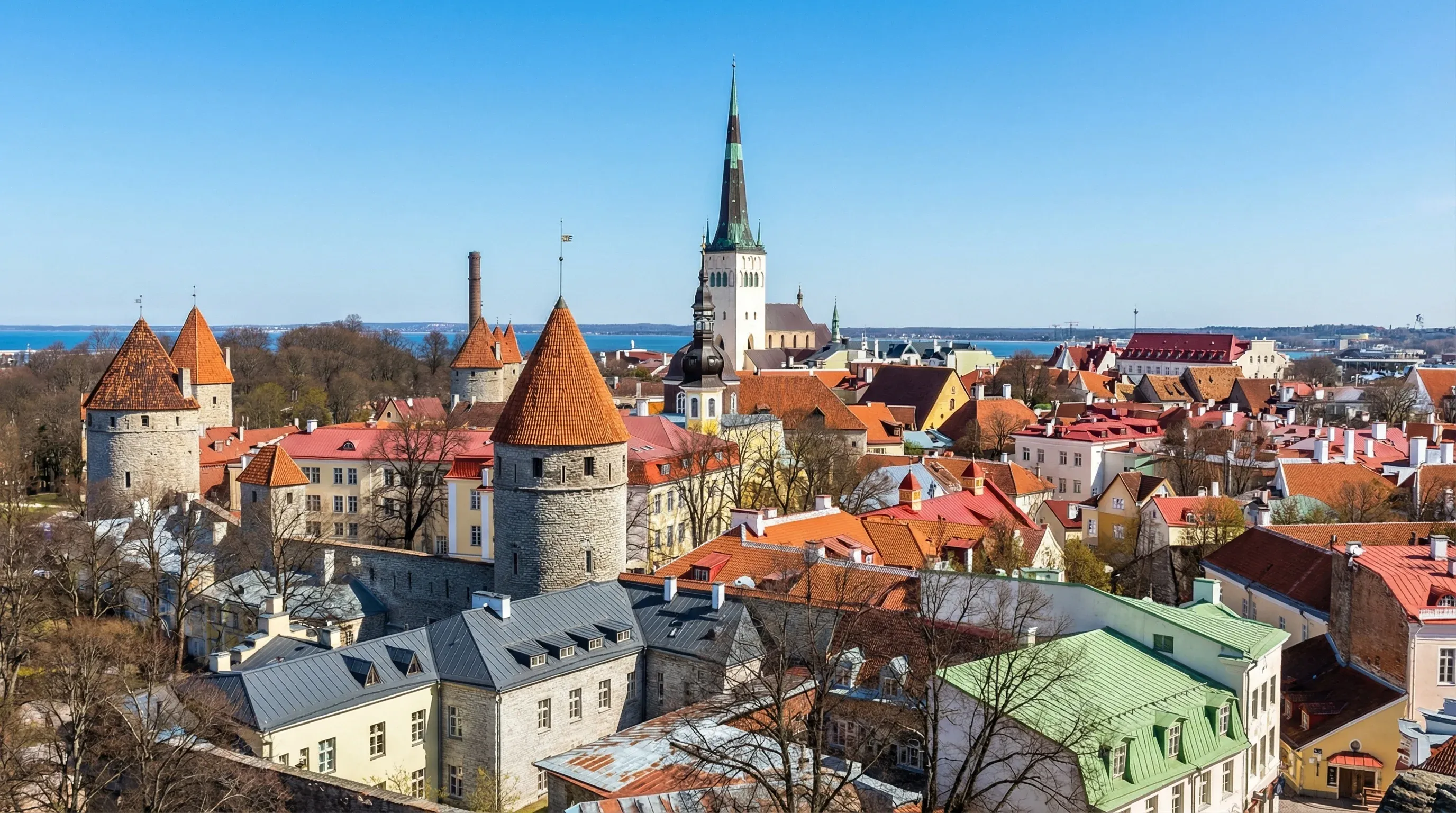 Panoramic view of red-tiled roofs and medieval towers in the Old Town of Tallinn, Estonia.