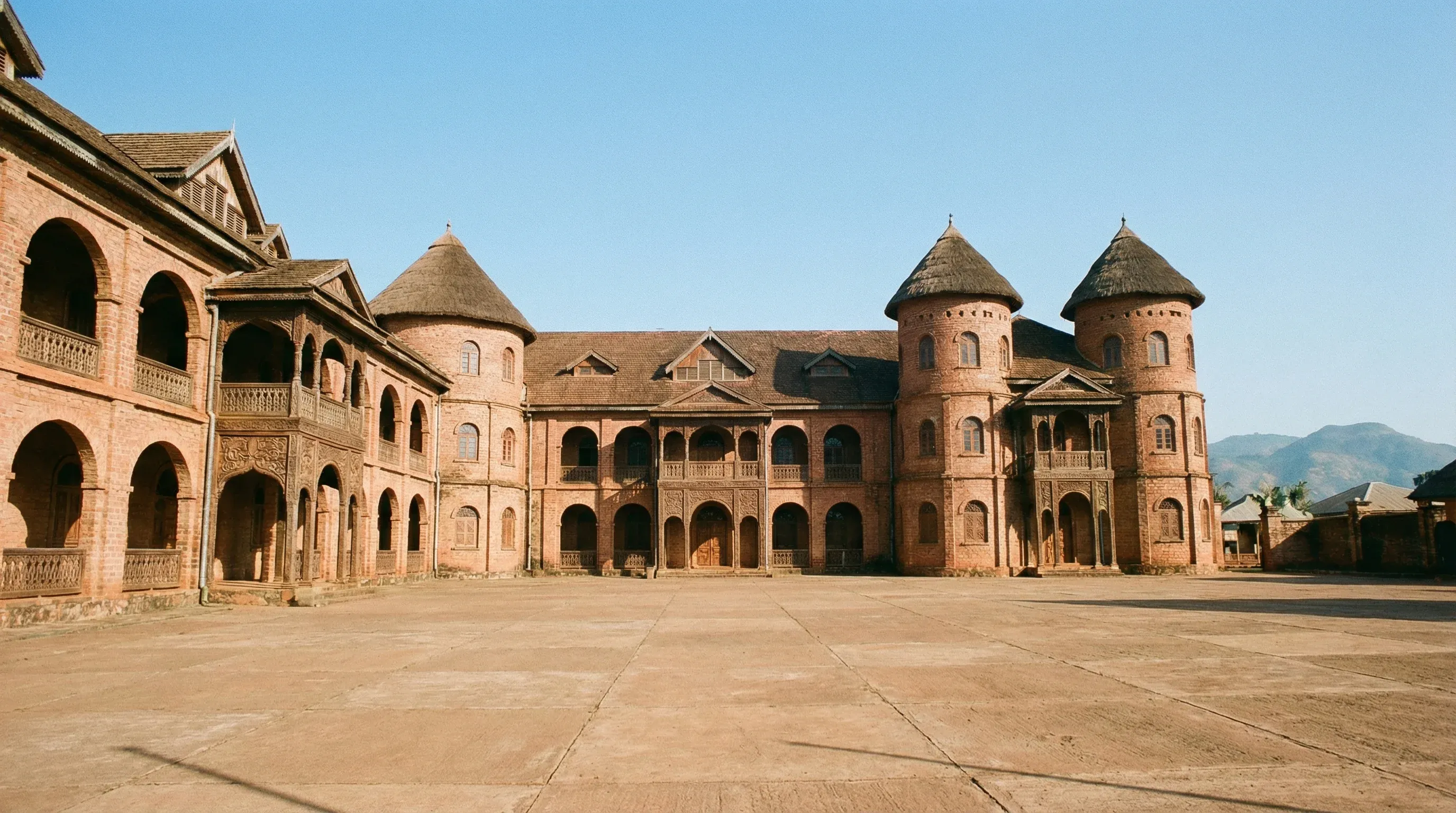 The historic red-brick facade and traditional architecture of the Royal Palace of Foumban in Cameroon.