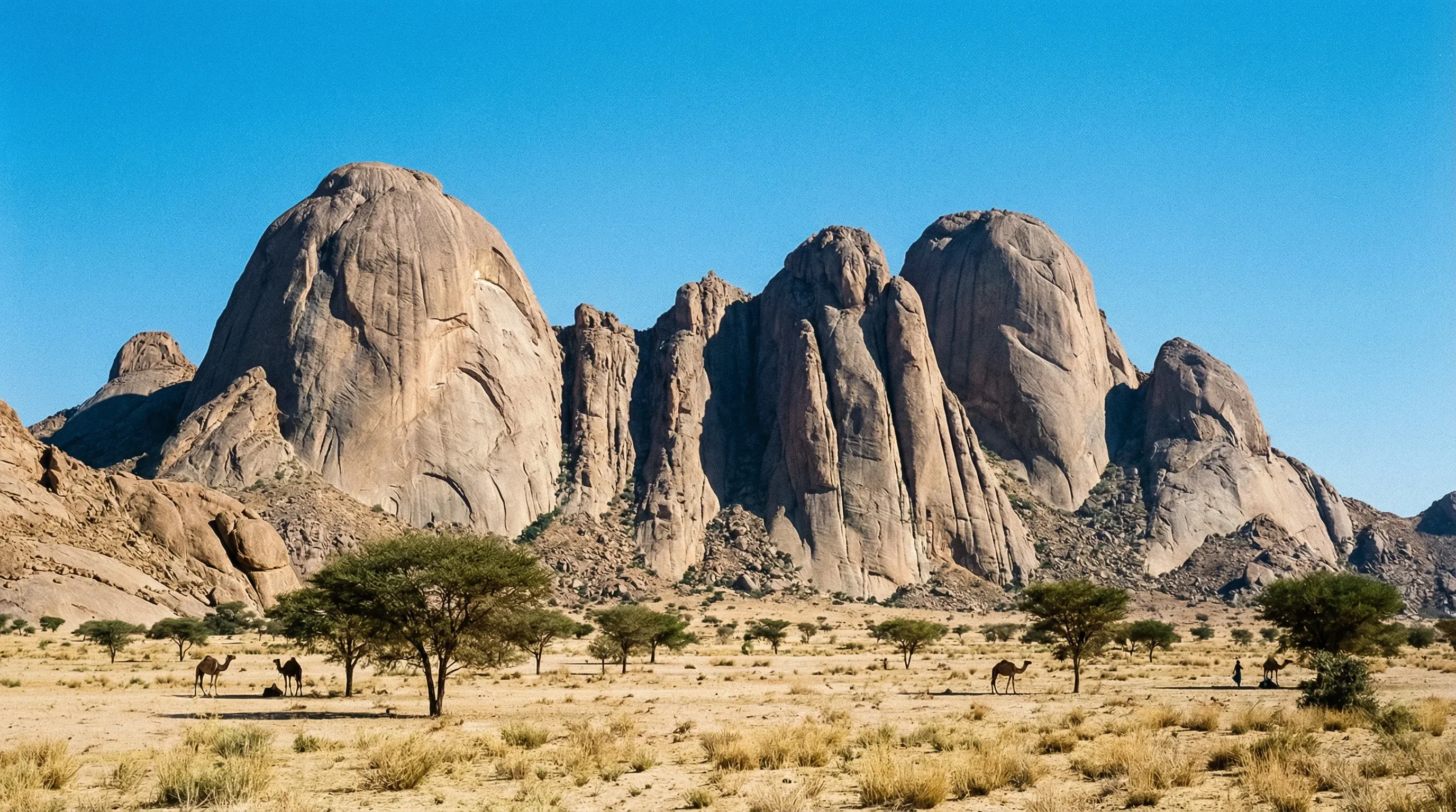 The distinctive smooth granite peaks of the Taka Mountains rising from the desert floor near Kassala.