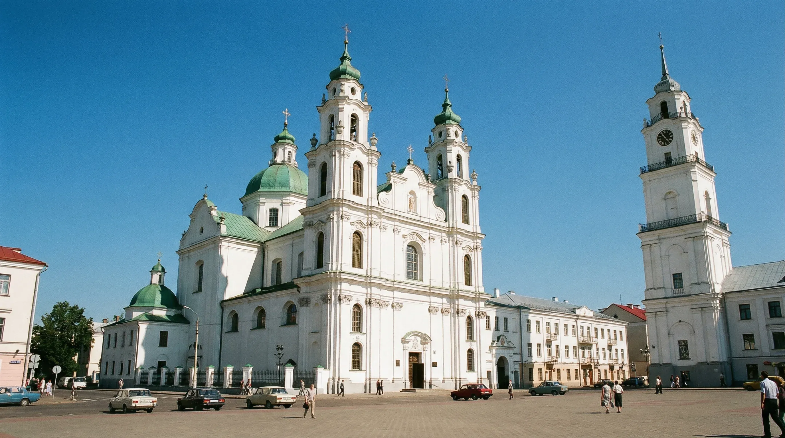 The white Baroque Holy Resurrection Church and the historic Town Hall tower in the center of Vitebsk.