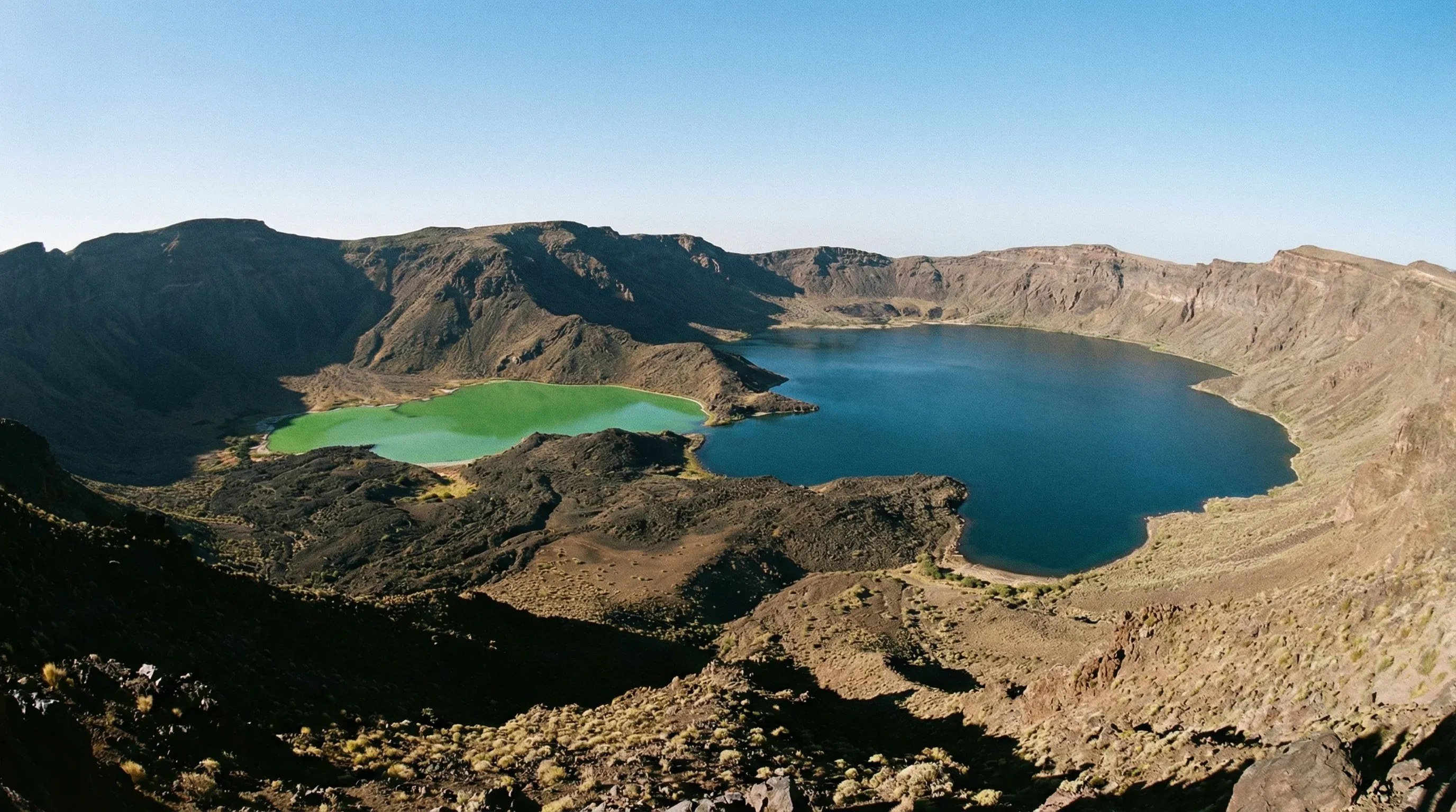 High-angle view overlooking the dual volcanic crater lakes of Deriba Caldera in the Jebel Marra mountains.
