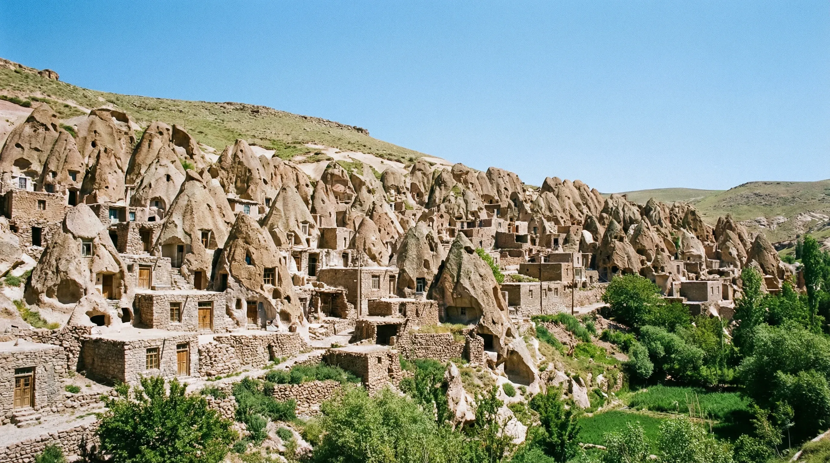 A hillside of cone-shaped rock formations that have been carved into traditional multi-story homes in Kandovan.