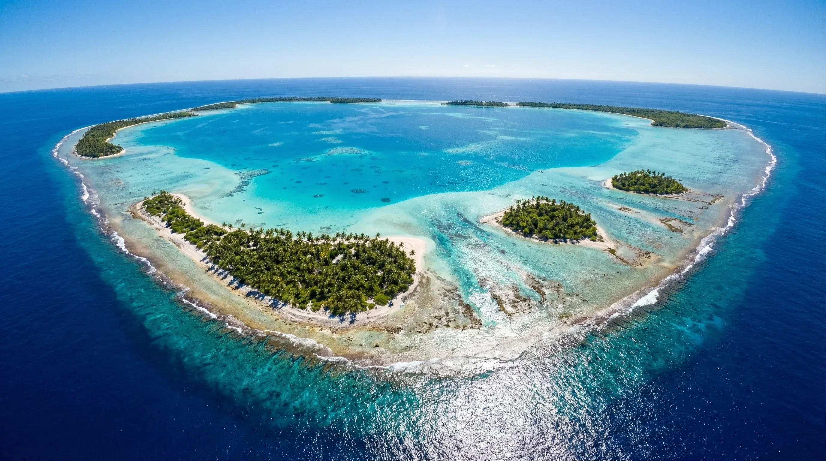 An aerial-style landscape view of the coral reef and tropical islets of Suwarrow Atoll in the Northern Cook Islands.