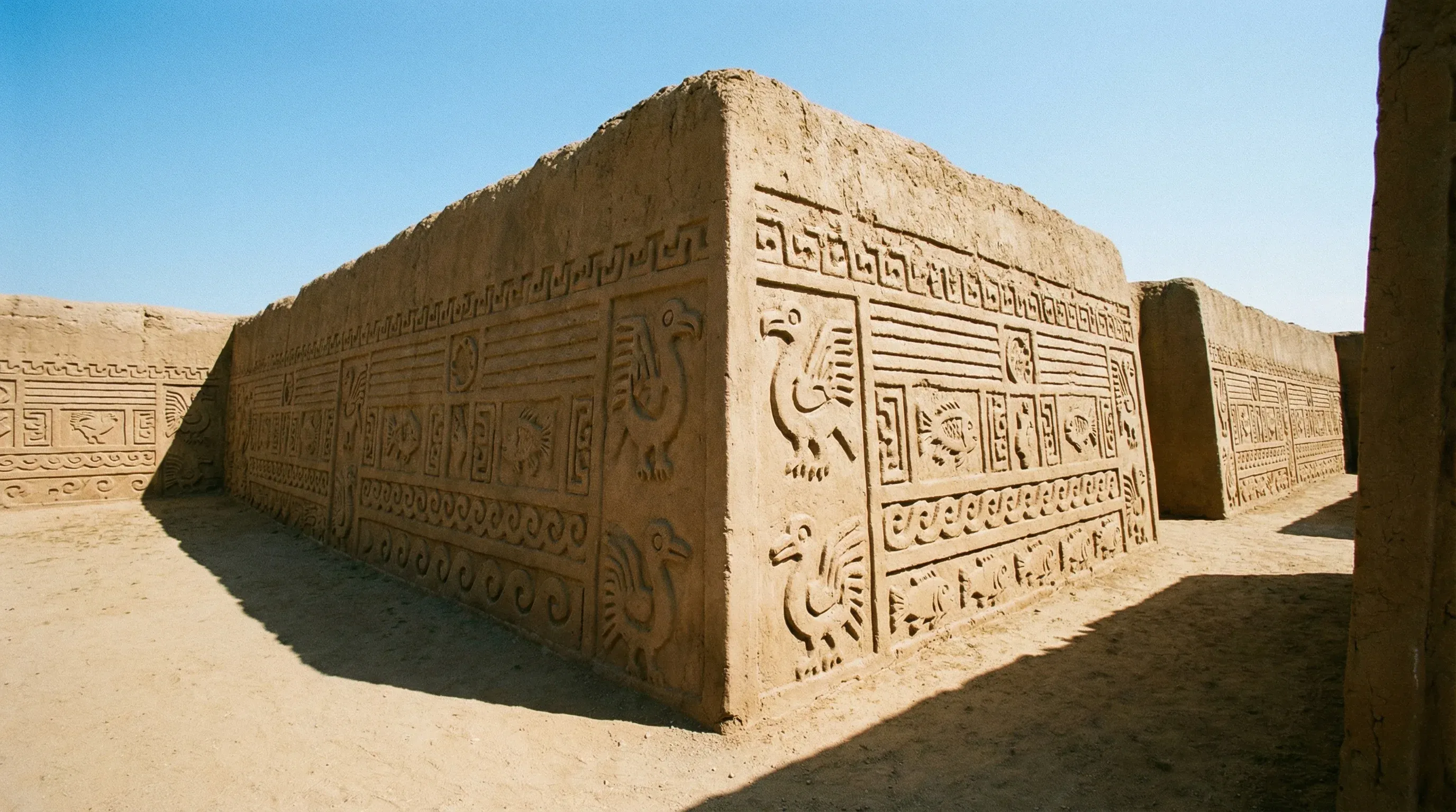 Intricate geometric mud-brick carvings on the ancient walls of the Nik An Palace at Chan Chan.