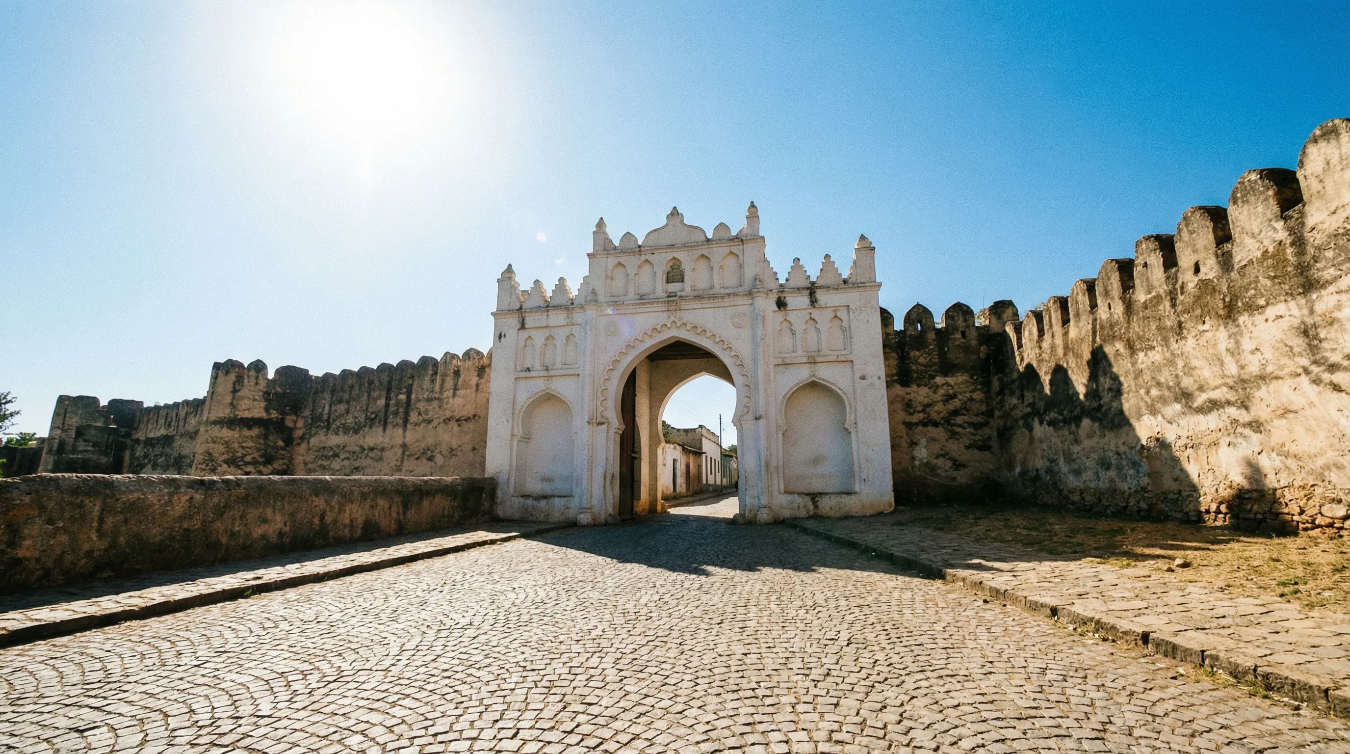 A historic white stone gate leading into the UNESCO World Heritage walled city of Harar Jugol, Ethiopia.