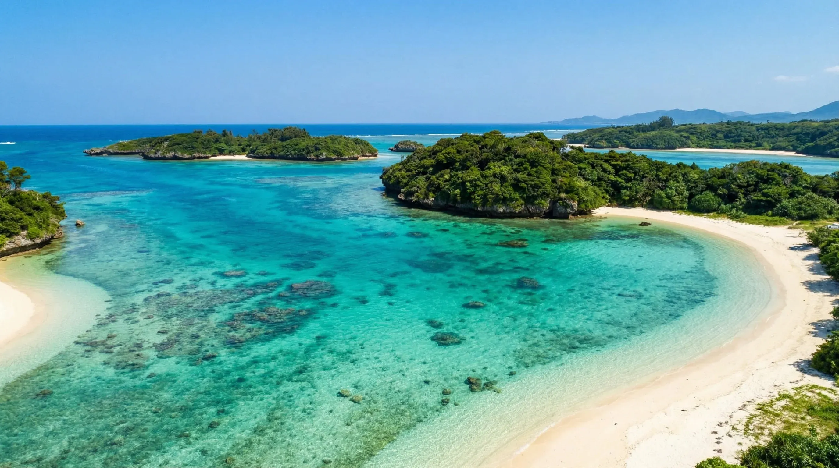 An elevated view of the turquoise water and forested islets of Kabira Bay on Ishigaki Island.