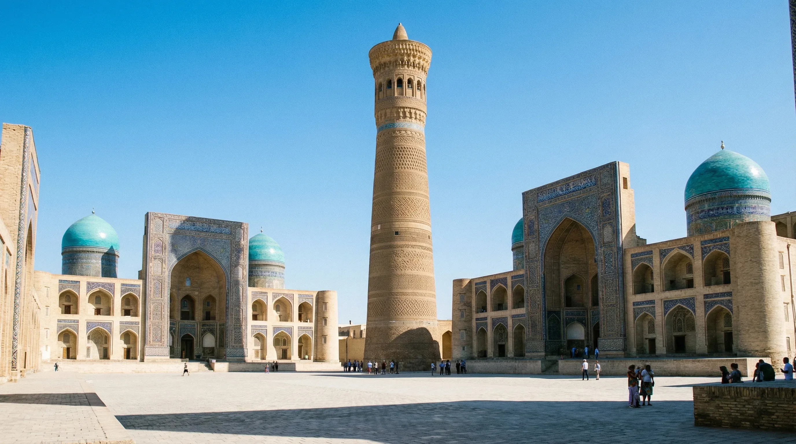 The brick Kalyan Minaret and the blue-domed Kalyan Mosque in the historic city of Bukhara.