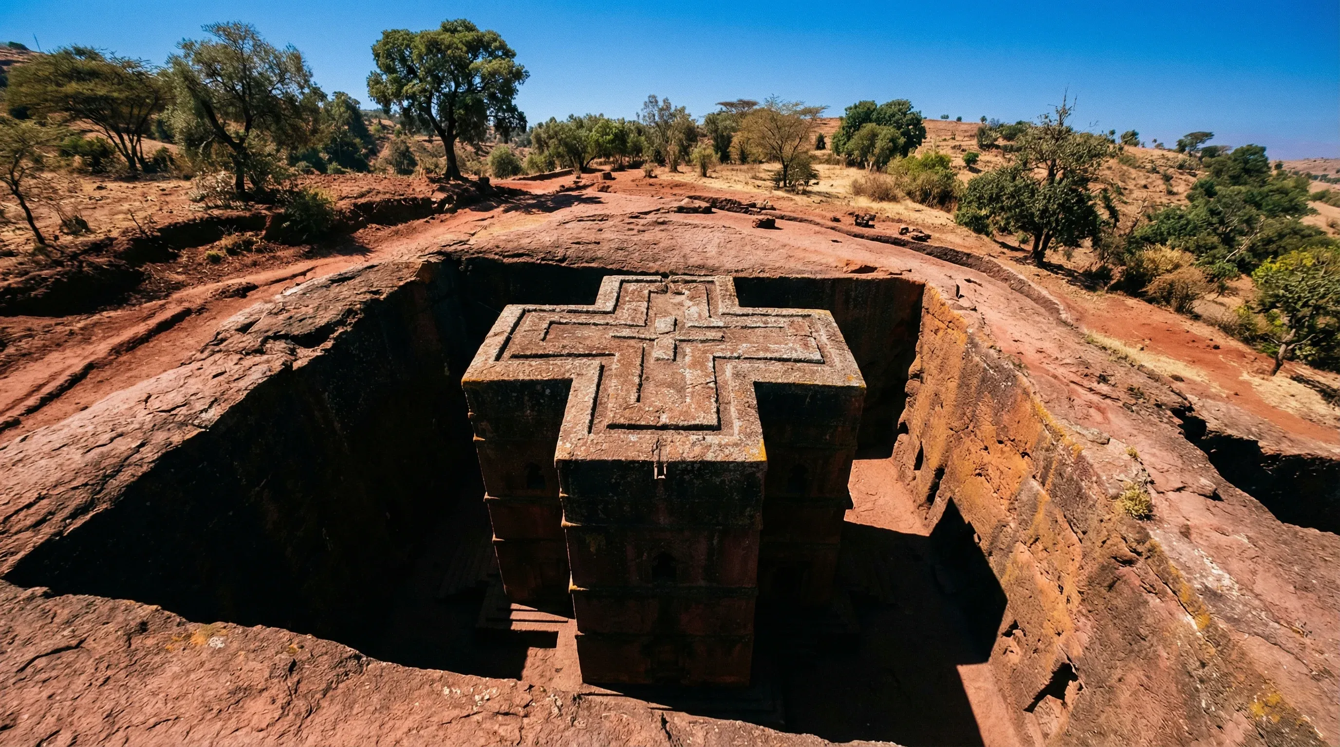 The monolithic, cross-shaped Church of Saint George carved into red volcanic rock in Lalibela, Ethiopia.