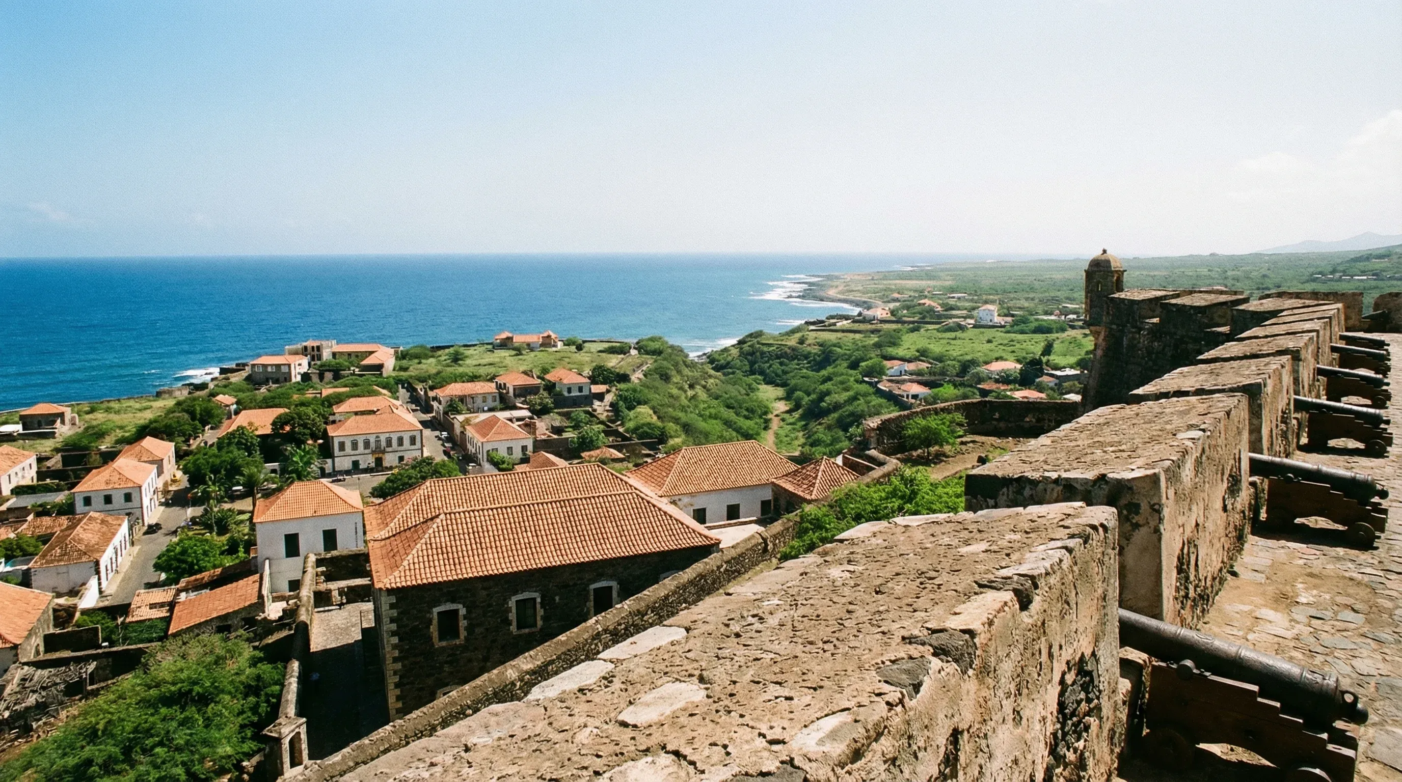 A view from a stone fortress overlooking the historic colonial buildings of Cidade Velha and the ocean on Santiago Island.