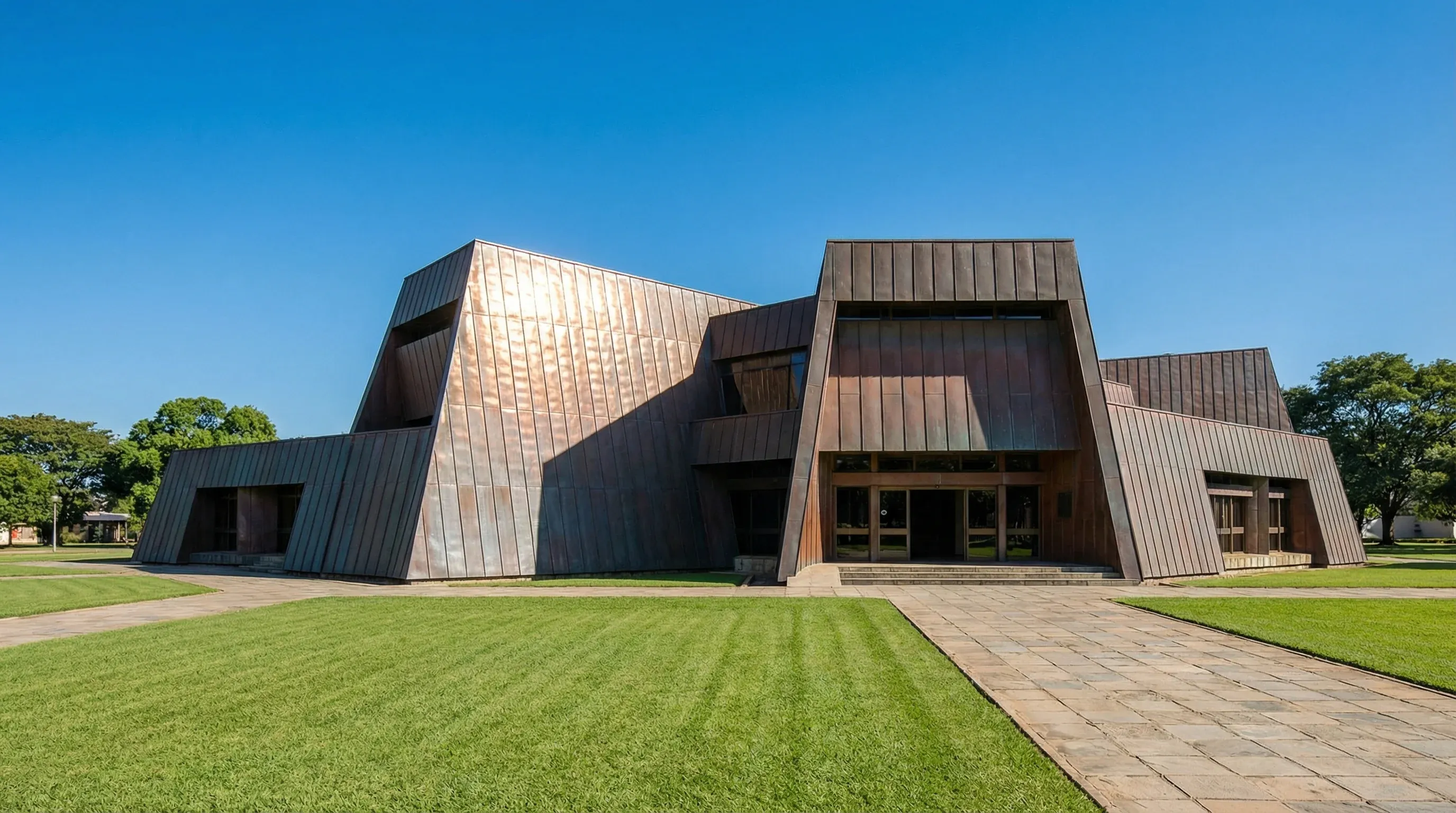 The National Assembly of Zambia building in Lusaka, featuring its unique copper-colored modernist architecture and green lawns under a bright sky.