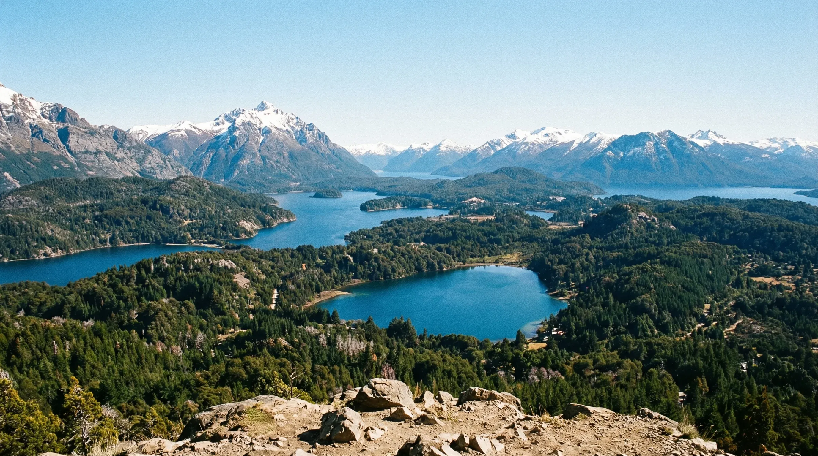 A high-angle view of blue lakes and snow-capped mountains in the Bariloche region of Northern Patagonia.