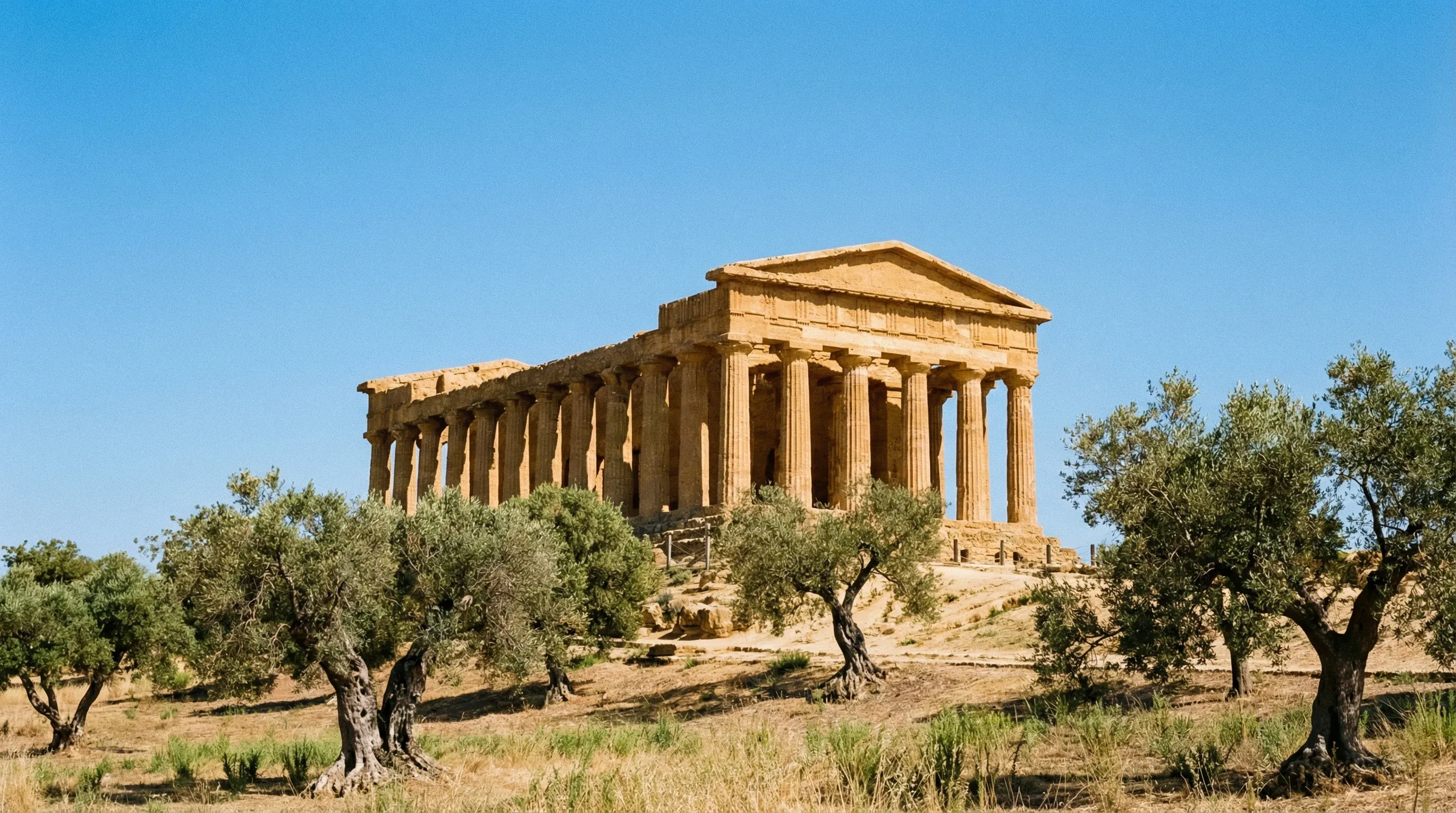 A well-preserved ancient Greek Doric temple made of golden sandstone in Agrigento, Sicily.