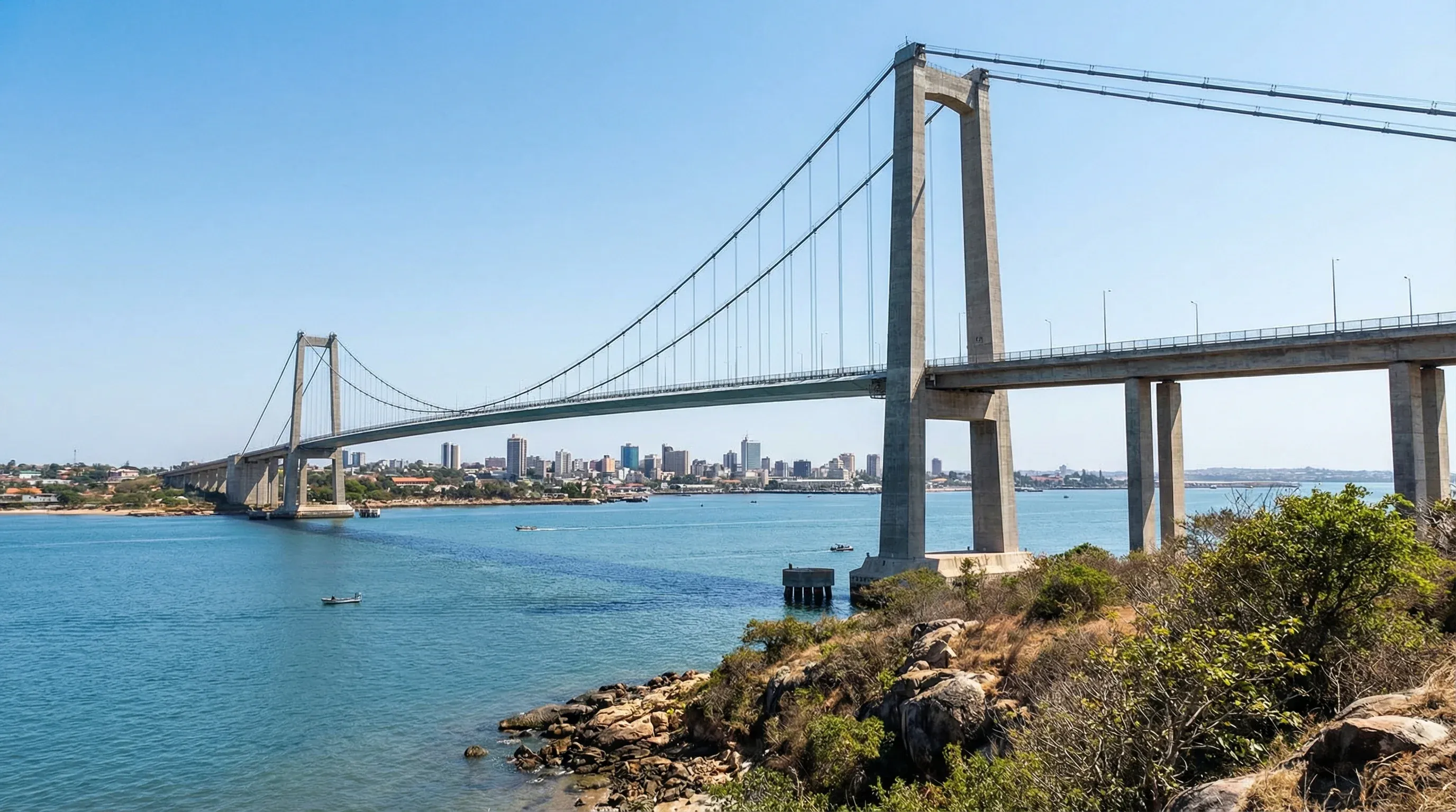 The Maputo-Katembe suspension bridge spanning the blue waters of Maputo Bay under a clear sky.